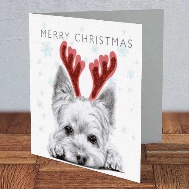 Yorkshire Terrier Christmas card by Matt Lloyd featuring a playful Yorkie wearing red glitter antlers, printed on 300gsm card, blank inside for message.