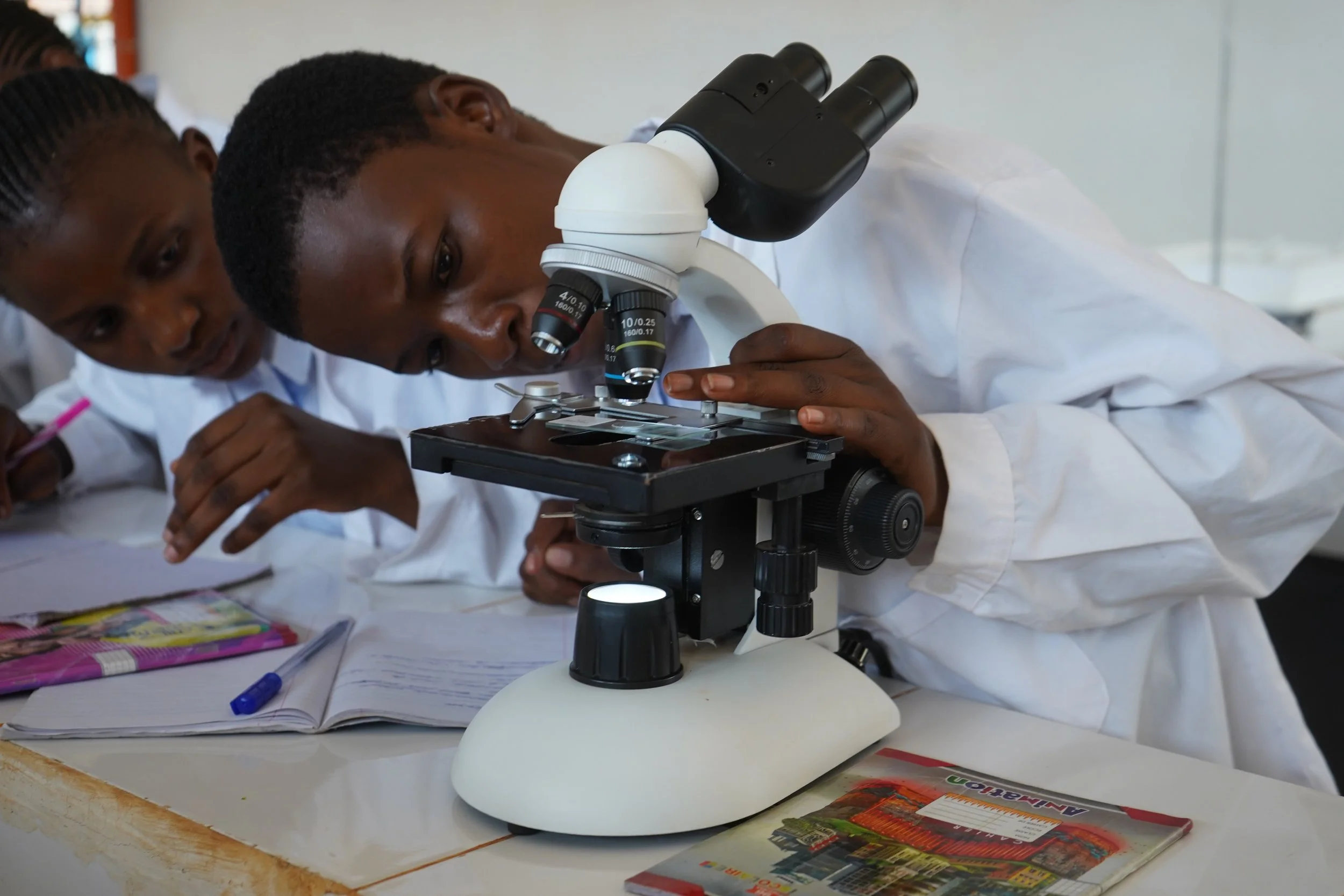 Young scholar with a microscope. 