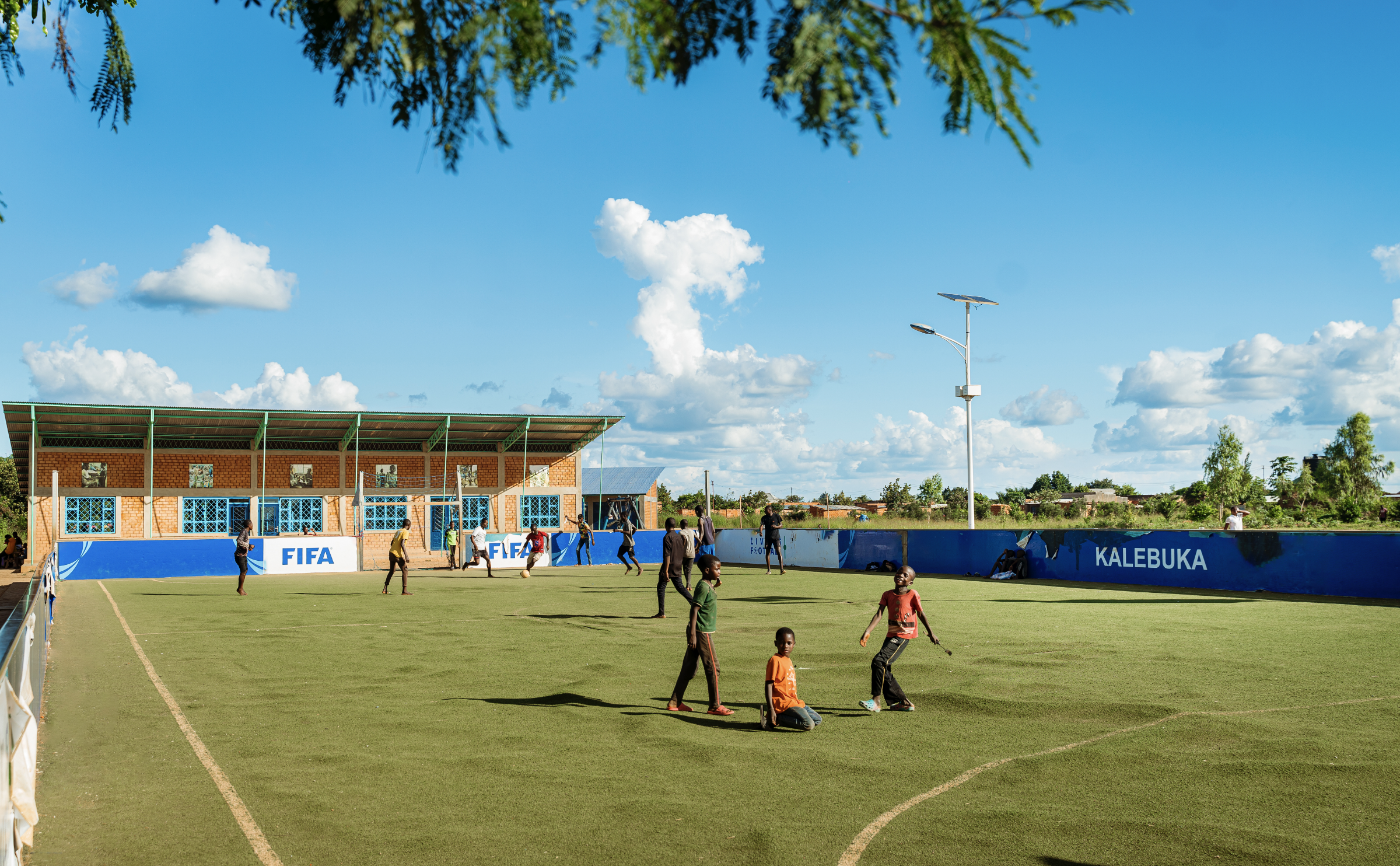 Local youth playing soccer on a field. 