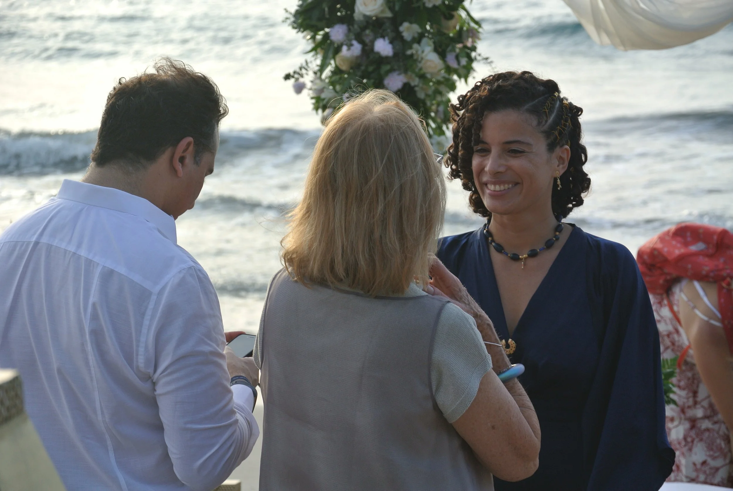 Bilingual celebrant Isa connecting with the groom's family at Blue Apple Beach atfer  formalizing the union through a deeply intentional symbolic ceremony.