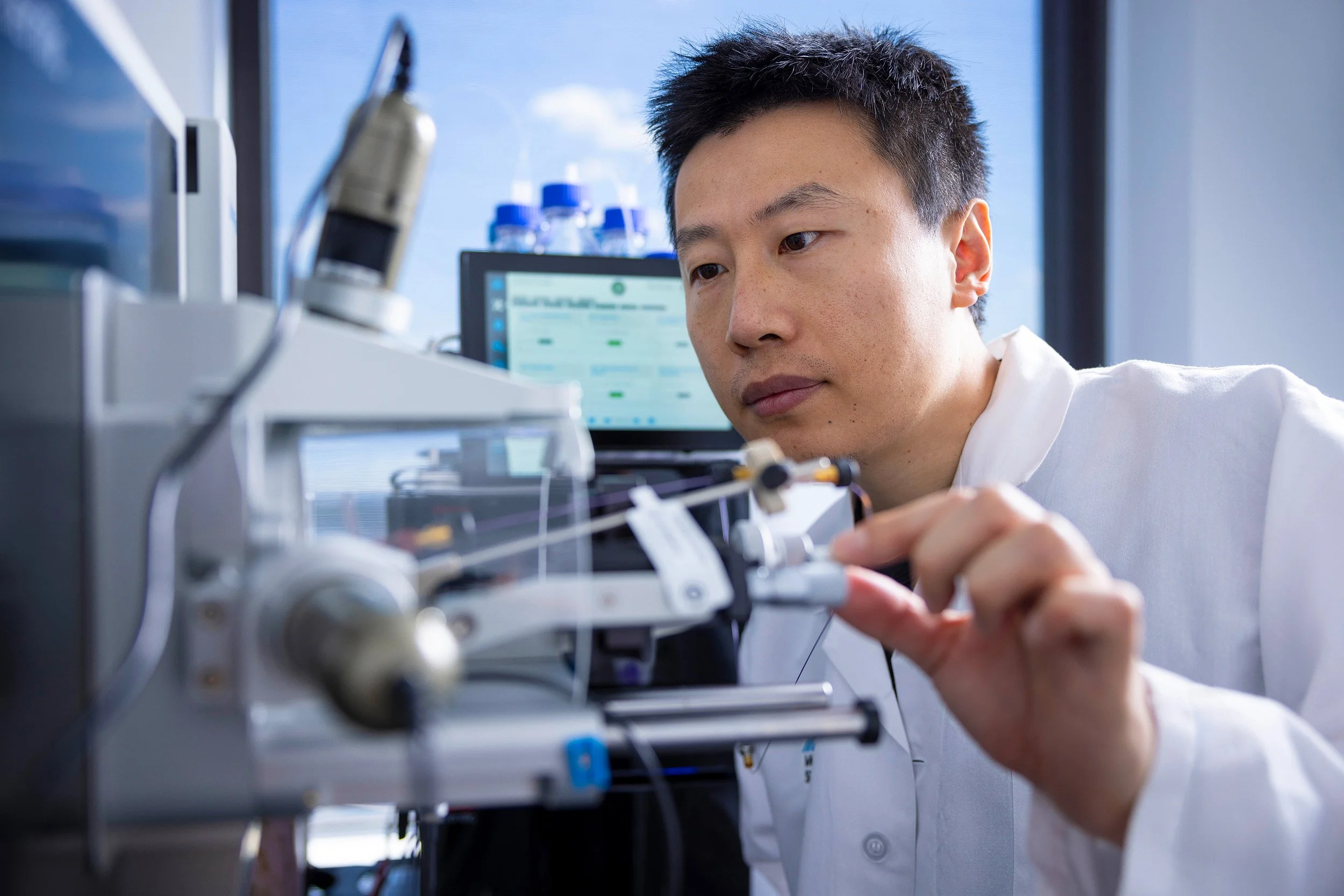 Scientist working with advanced equipment in a research facility.