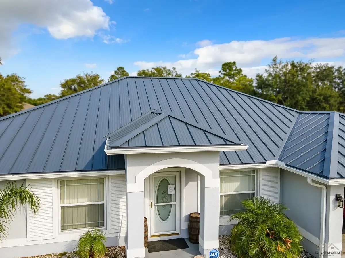 Close-up view of a vibrant gray standing seam metal roof installation by Craig Fass Roofing in Brooksville, FL on a bright sunny day.