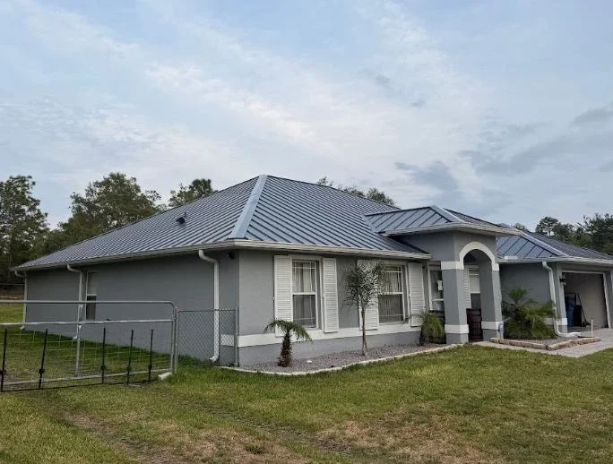 Completed metal roof installation by Craig Fass Roofing in Brooksville, FL, providing durable protection for a residential home.