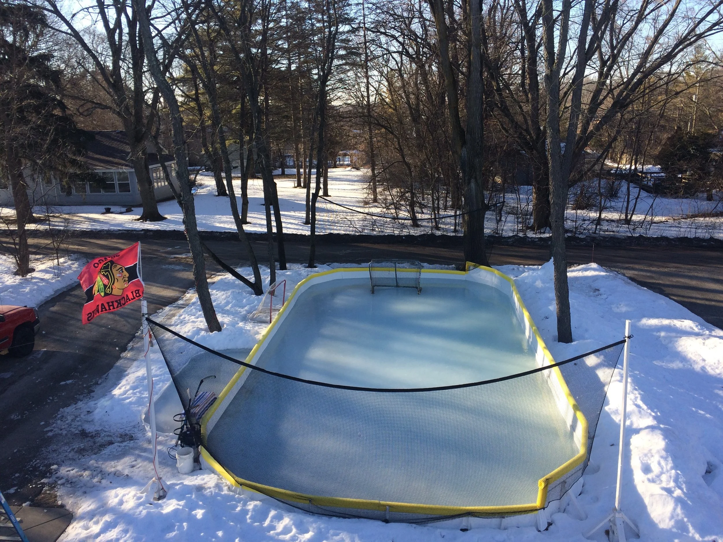 Should you use hot water or cold water to flood a backyard rink
