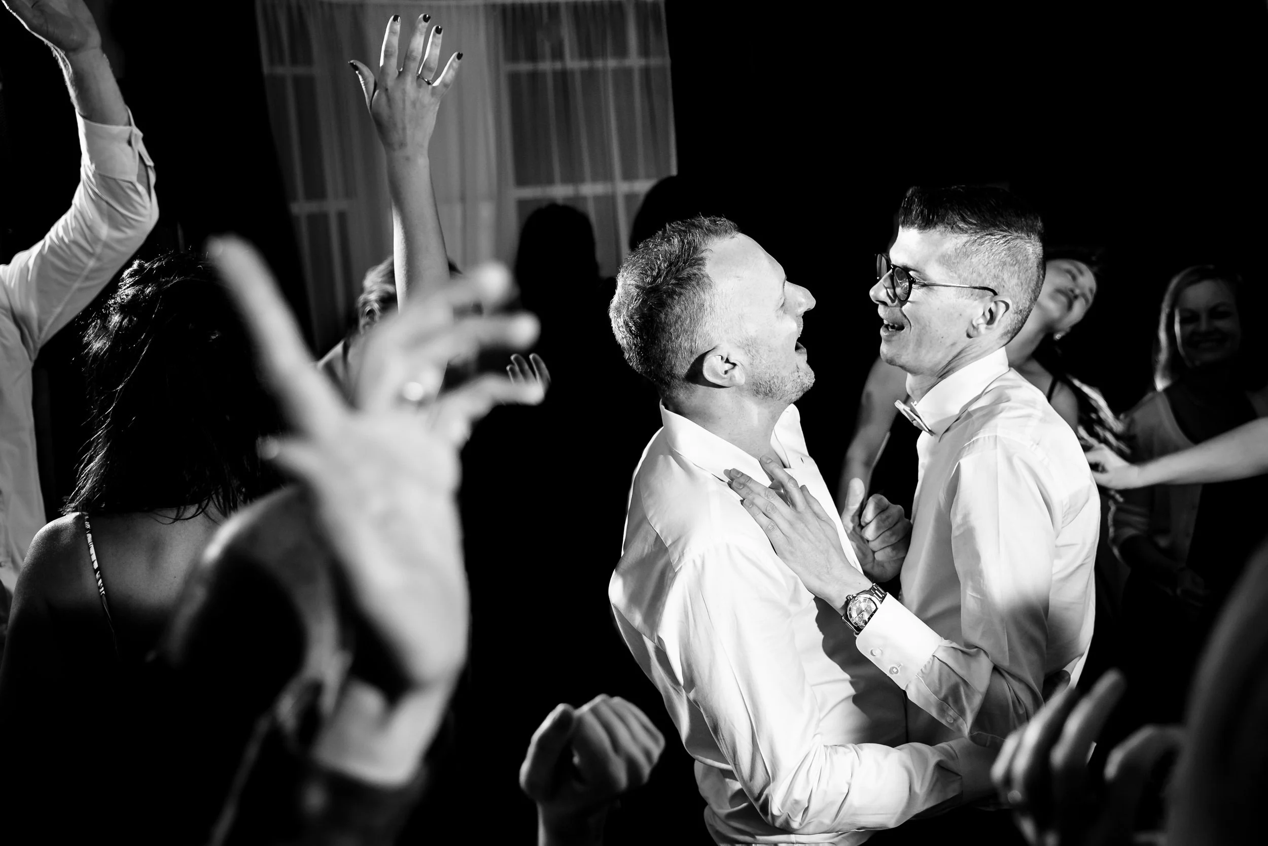 A black and white photograph of people dancing at a wedding reception at The Anchorage Hotel & Spa, Port Stephens.