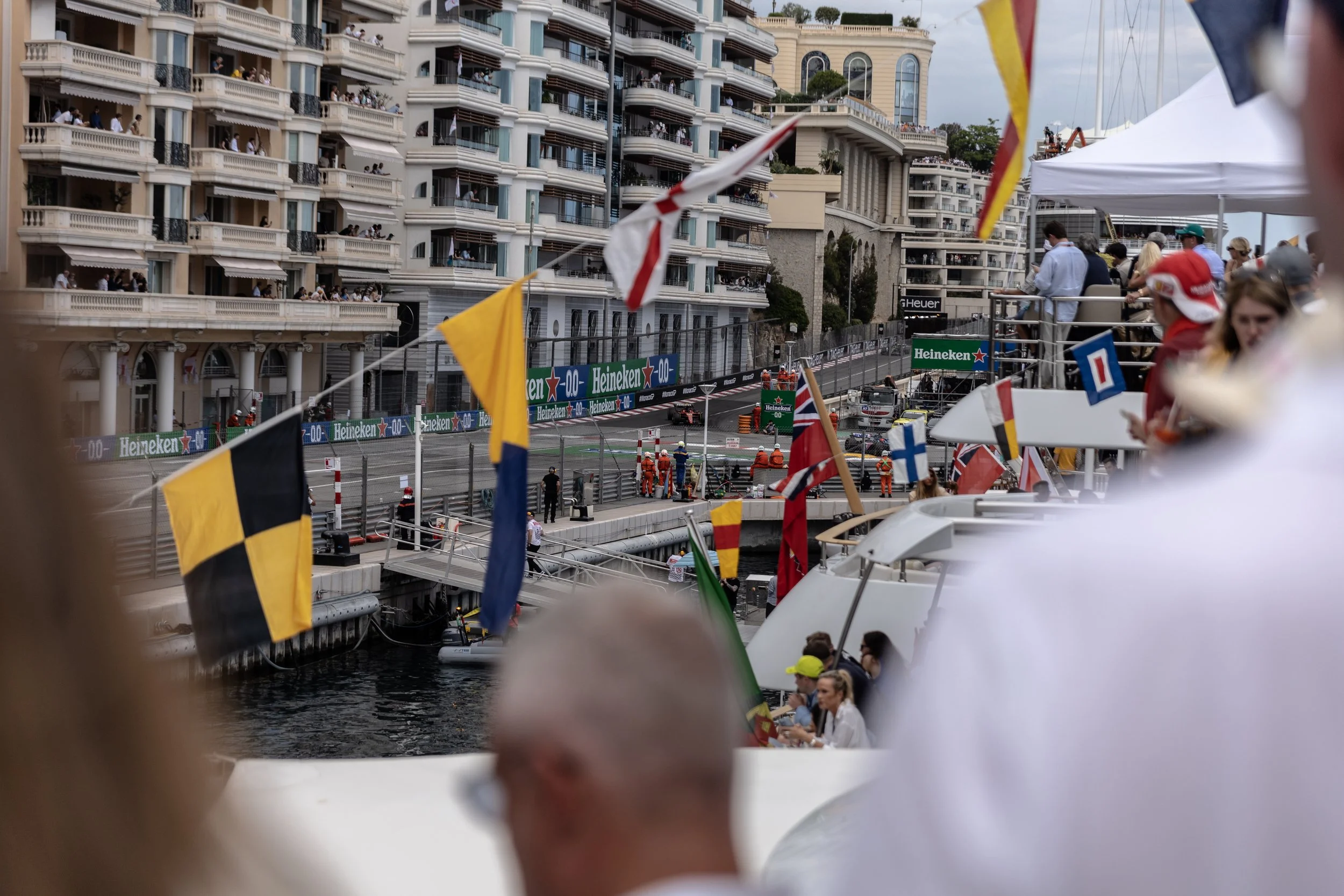Fans watch on from luxury yachts in Monaco harbour as race cars compete in the streets of Monte Carlo