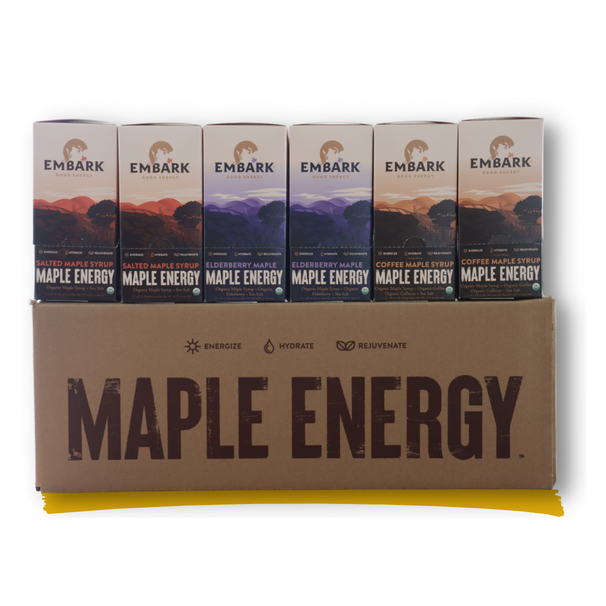 Six cartons of Embark Maple Energy drinks with flavors including salted maple syrup, elderberry maple, and coffee maple syrup stacked on a brown cardboard box labeled Maple Energy.