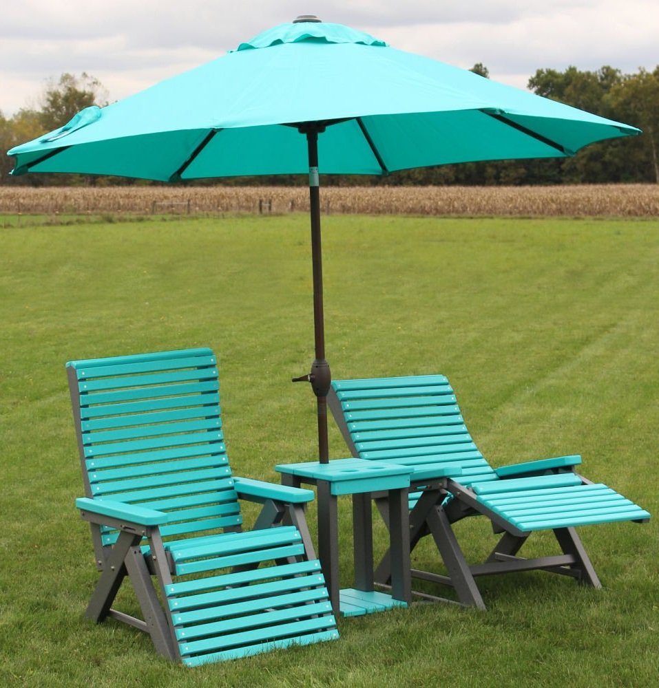 Outdoor lounge chairs and umbrella on grass