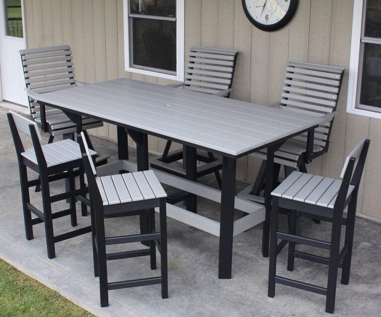 Outdoor dining set with a gray table and black and gray chairs on a patio.