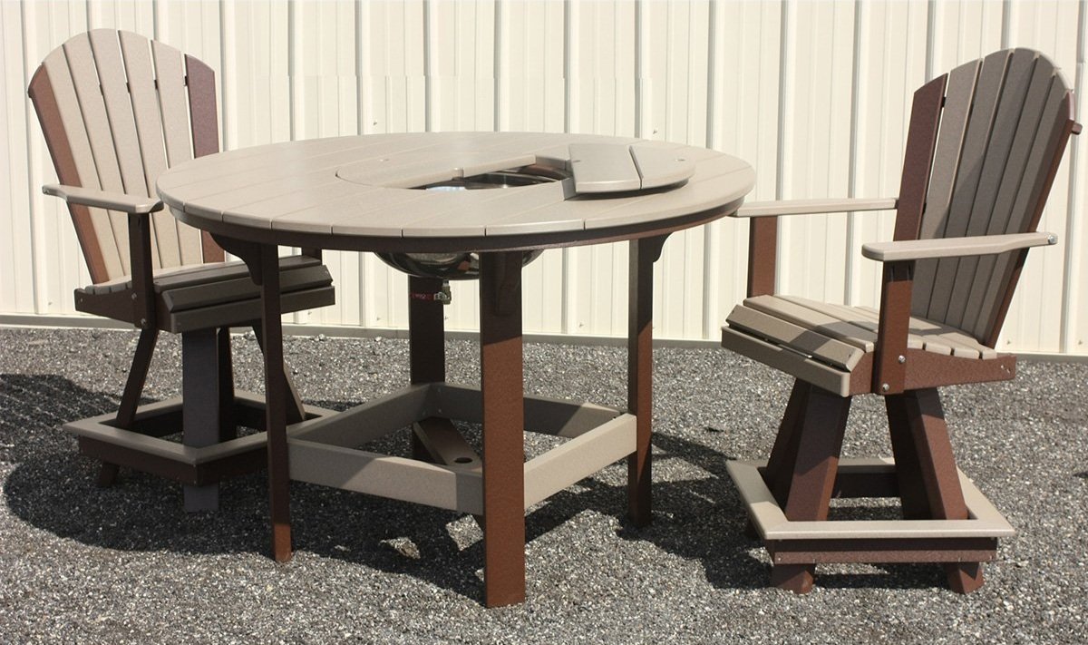 Outdoor round patio table with two matching chairs on gravel surface.