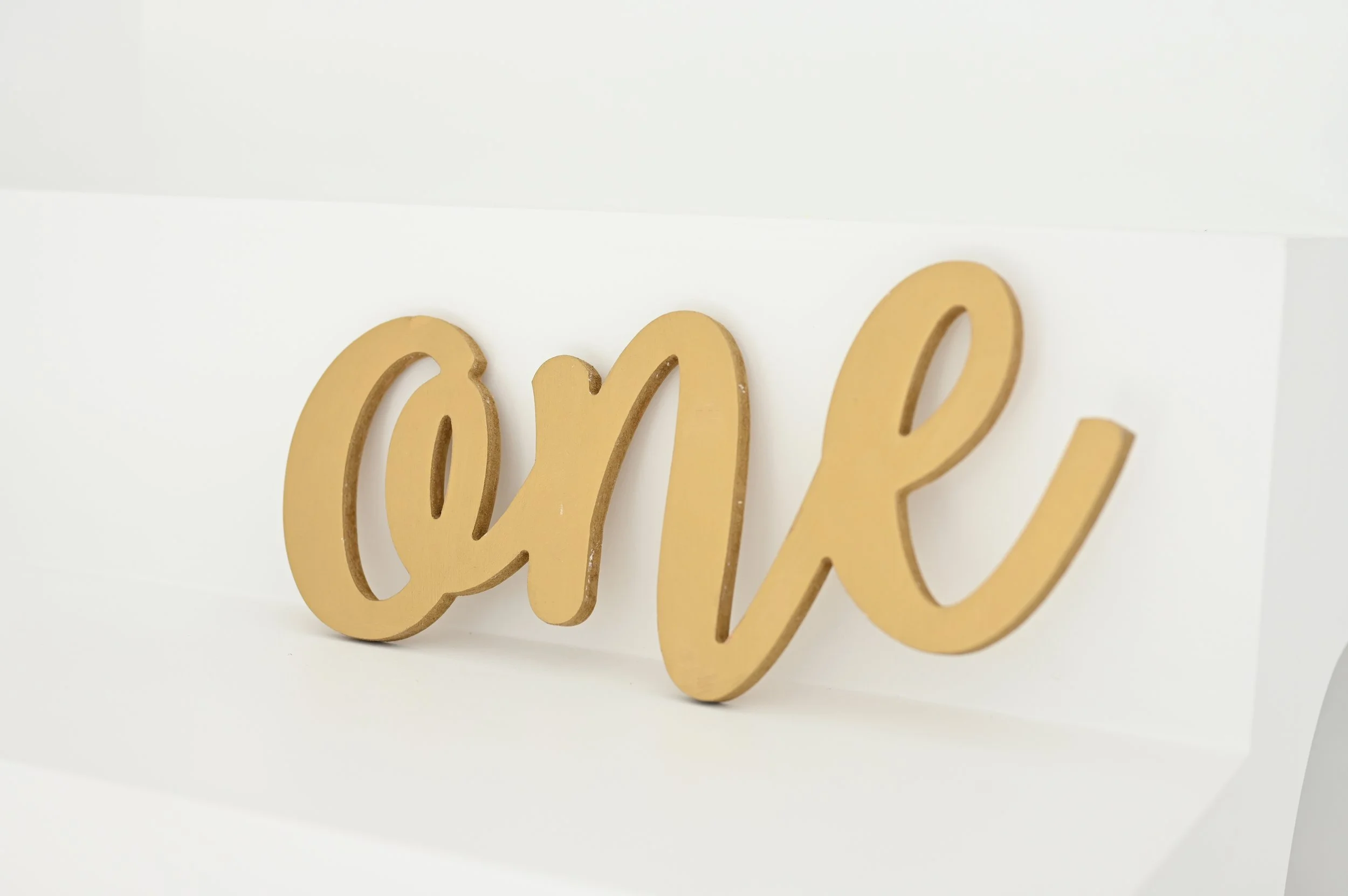 Gold “One” Script Sign