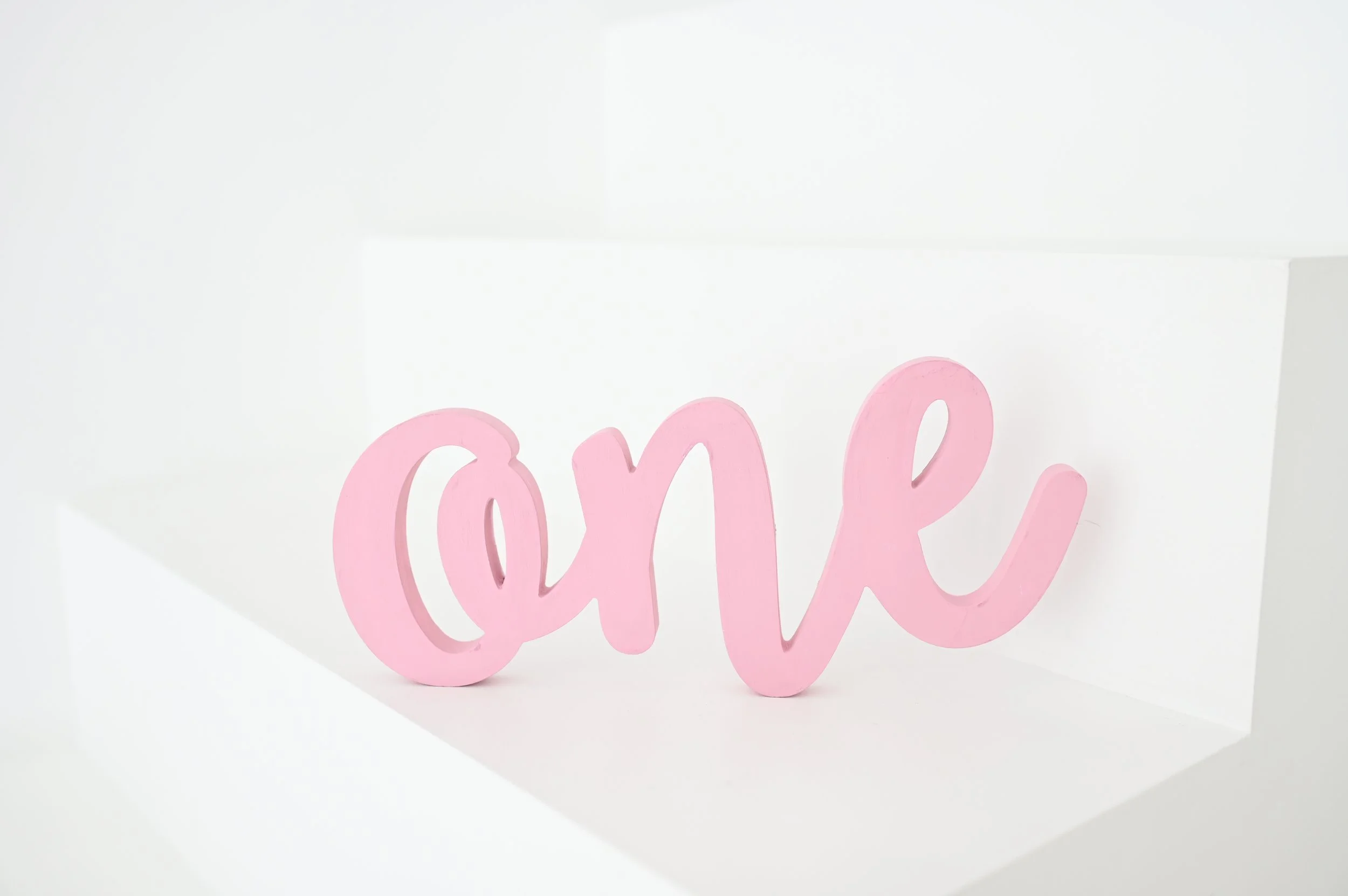 Pink “ONE” Cursive Letters