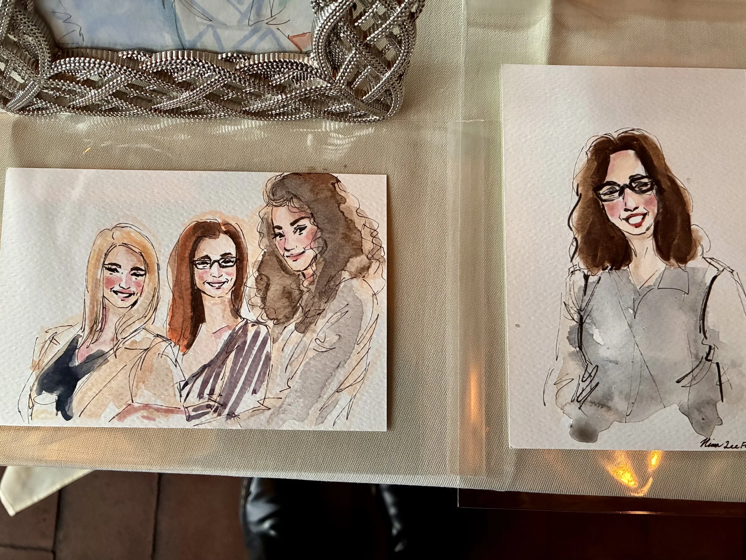 Watercolor portraits of three women with varied hair colors and styles, wearing glasses, depicted on separate pieces of paper painted live by Nina Lee Avis in Chicago, IL.
