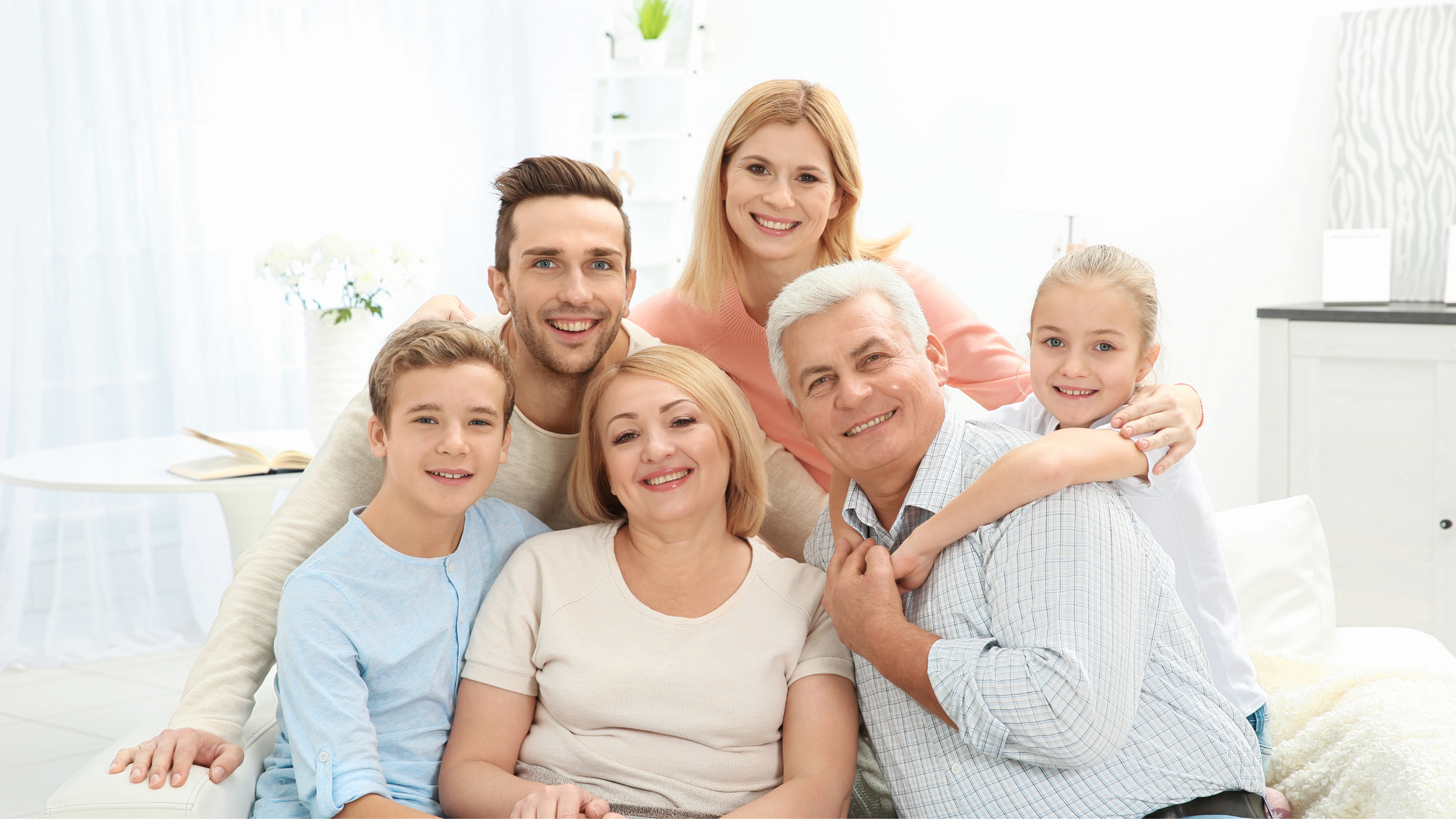 Happy multigenerational family gathered in a bright living room