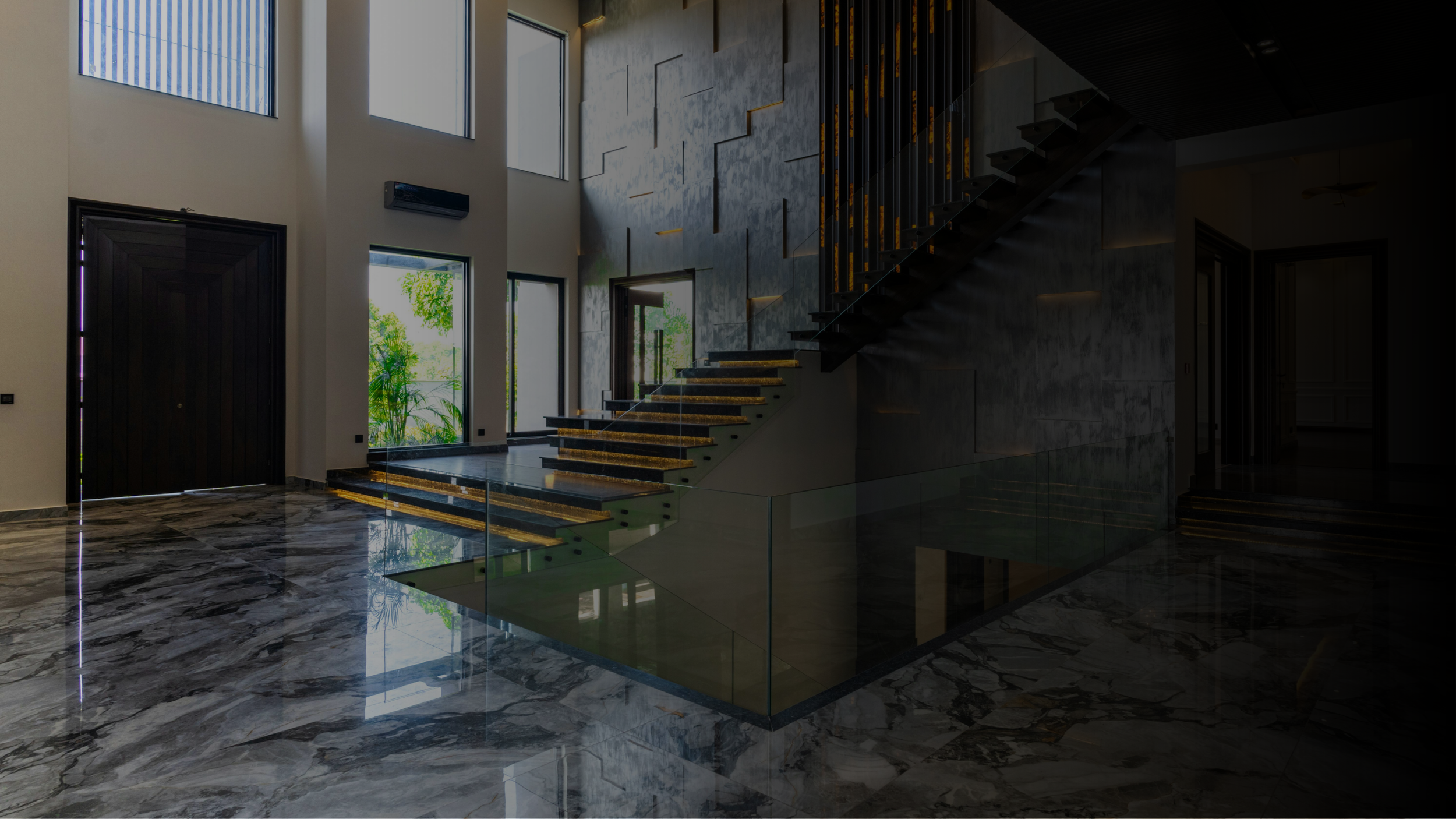 Modern interior with marble flooring, large windows, a staircase with glass railings, and decorative wall panels.