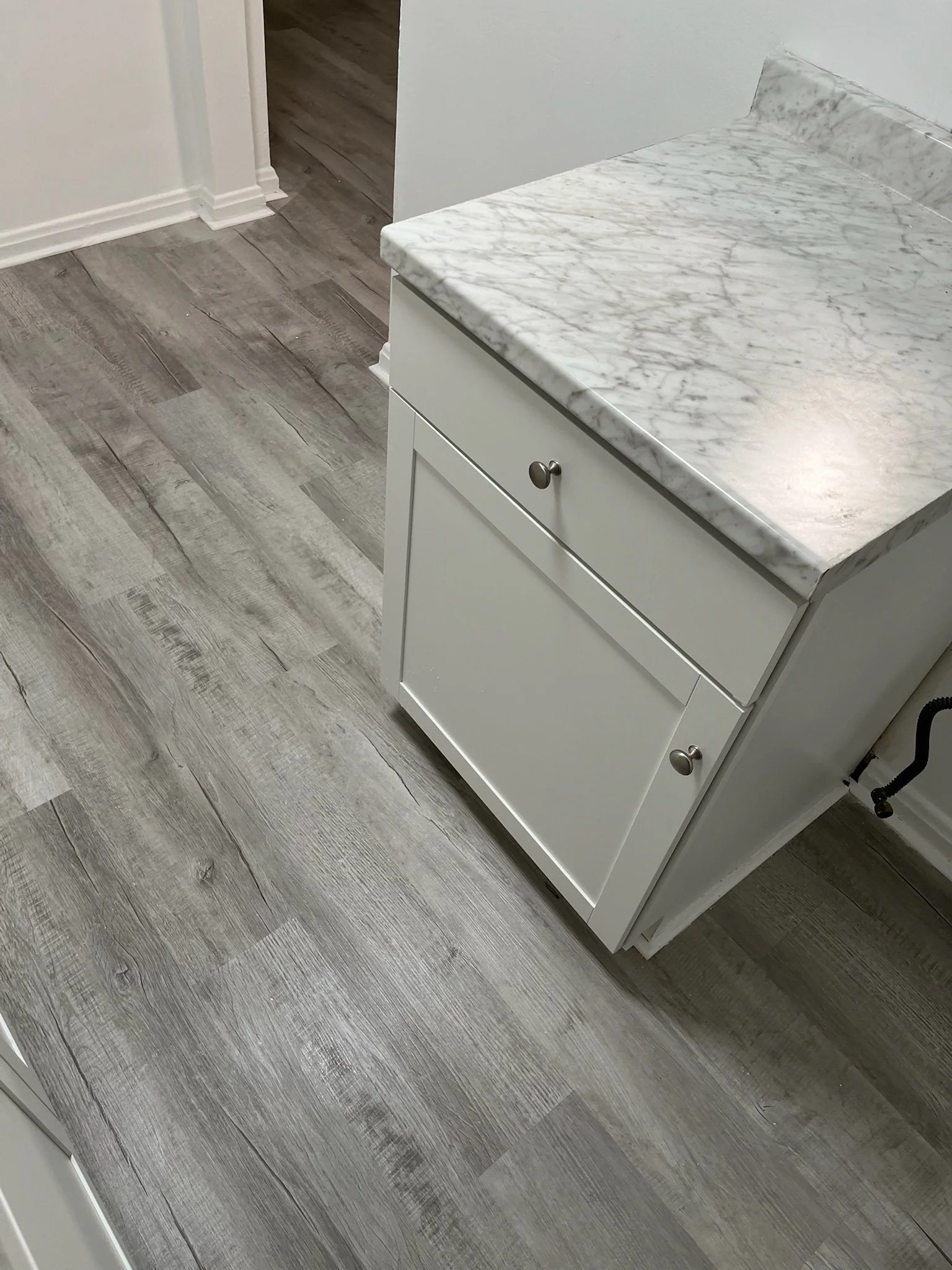 modern kitchen flooring Dayton Ohio LVP installation with marble countertops and shaker cabinets