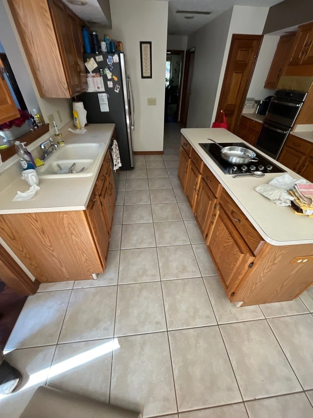 kitchen flooring before renovation Dayton Ohio worn tile floor with oak cabinets