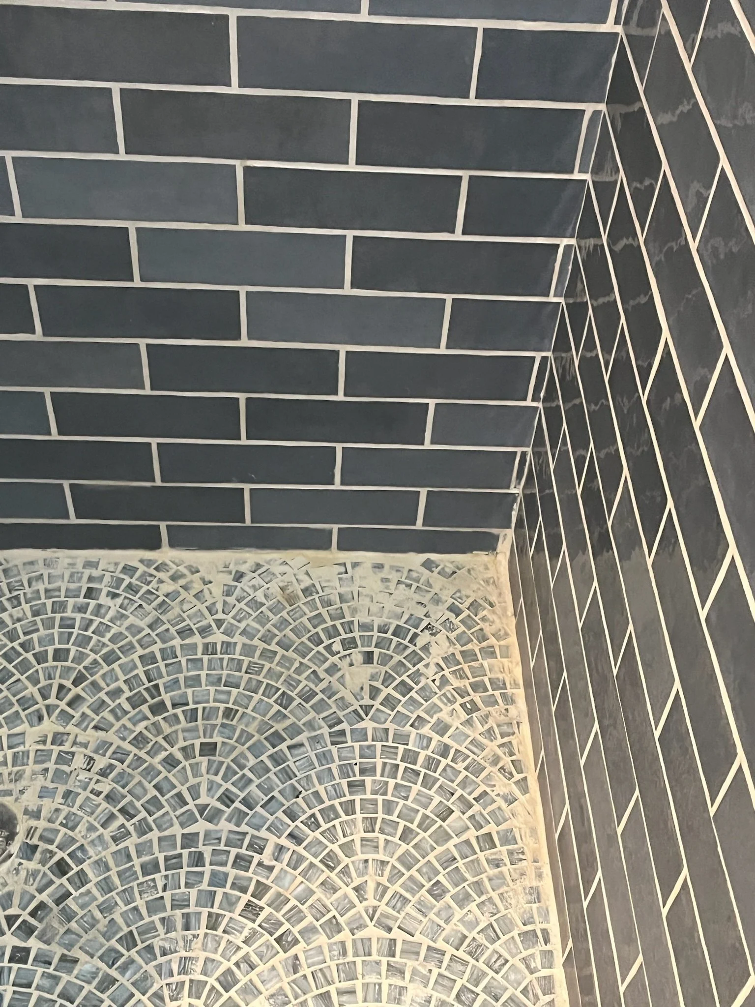 damaged shower tile before renovation Dayton Ohio cracked tile and worn mosaic shower floor