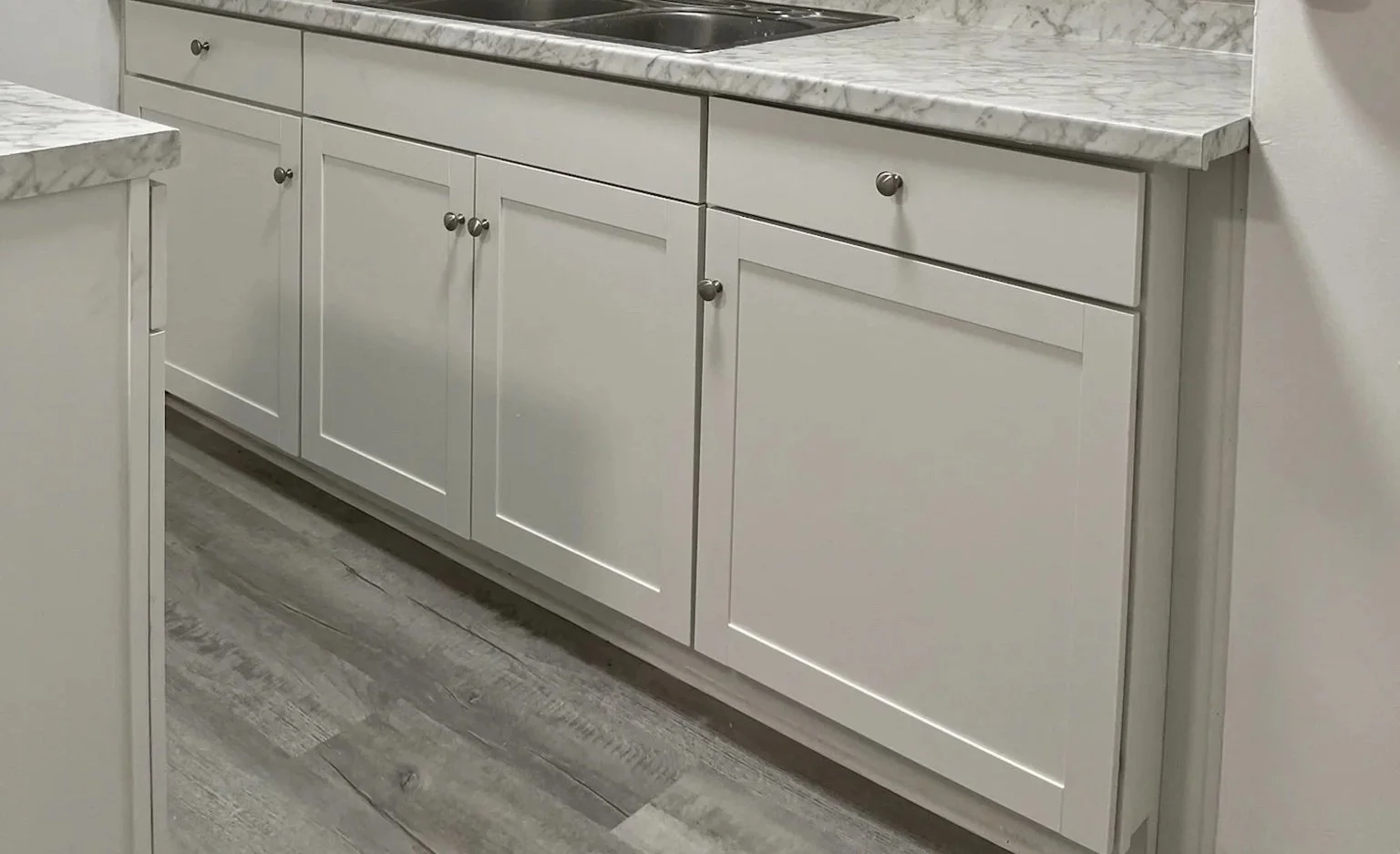 kitchen LVP flooring installation Dayton Ohio gray wood look vinyl plank with white cabinets