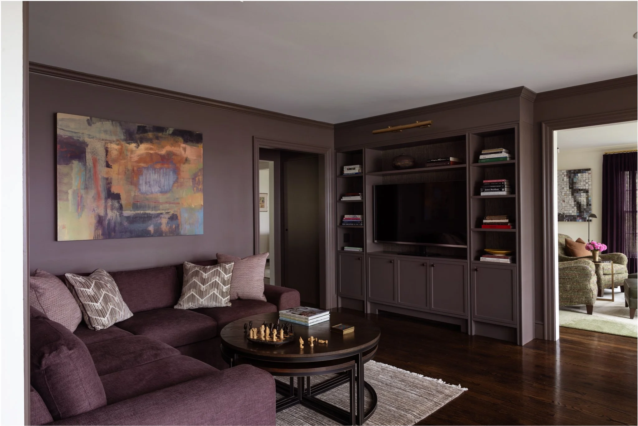 A moody family room in deep plum and burgundy in Litchfield County CT photographed by AD 100 NYC interiors hospitality lifestyle photographer Regan Wood