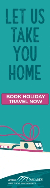 Amtrak Cascades holiday travel ad featuring a train with the text 'Let us take you home. Book holiday travel now.'