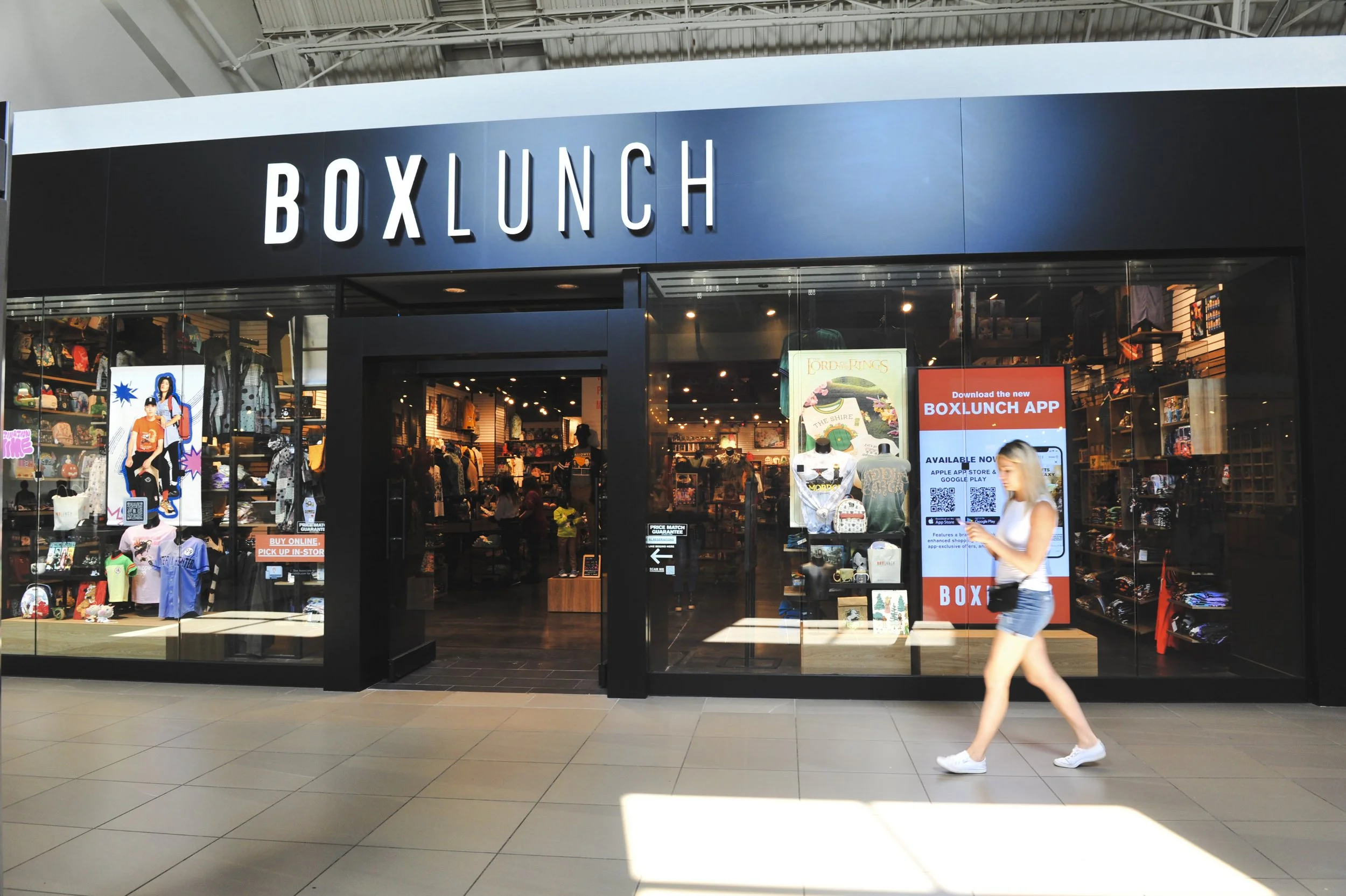 Entrance of a BoxLunch store with displays and signs in a shopping mall.