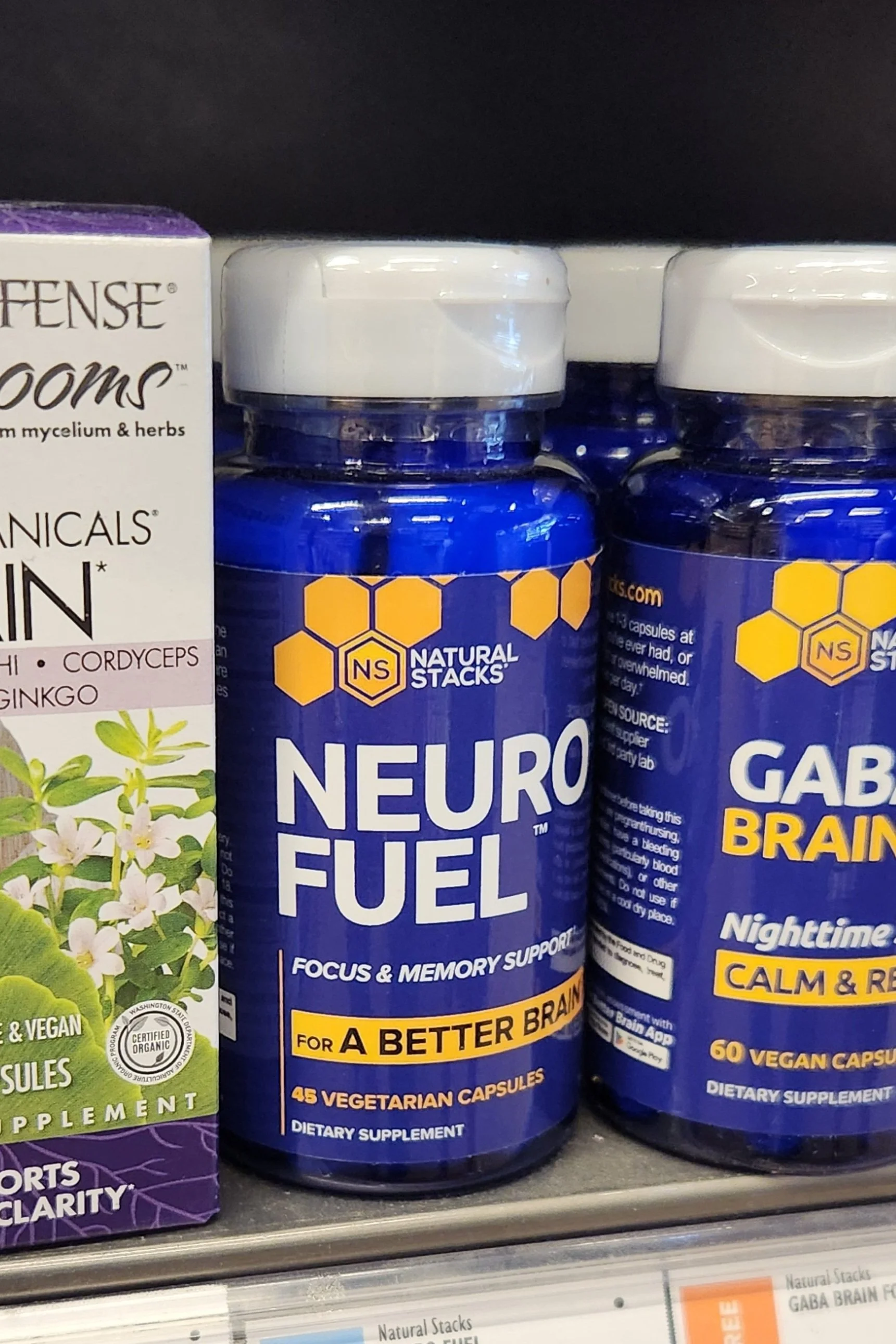 Natural Stacks Neuro Fuel and GABA Brain Food supplements on shelf; Neuro Fuel label reads "Focus & Memory Support".