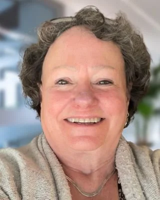Close-up of a smiling mature woman who is an experienced therapist.