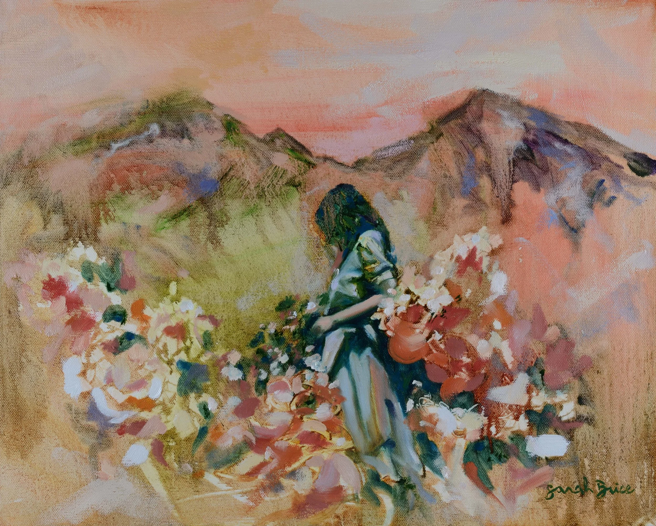 Woman stands in a flower meadow framed by mountains