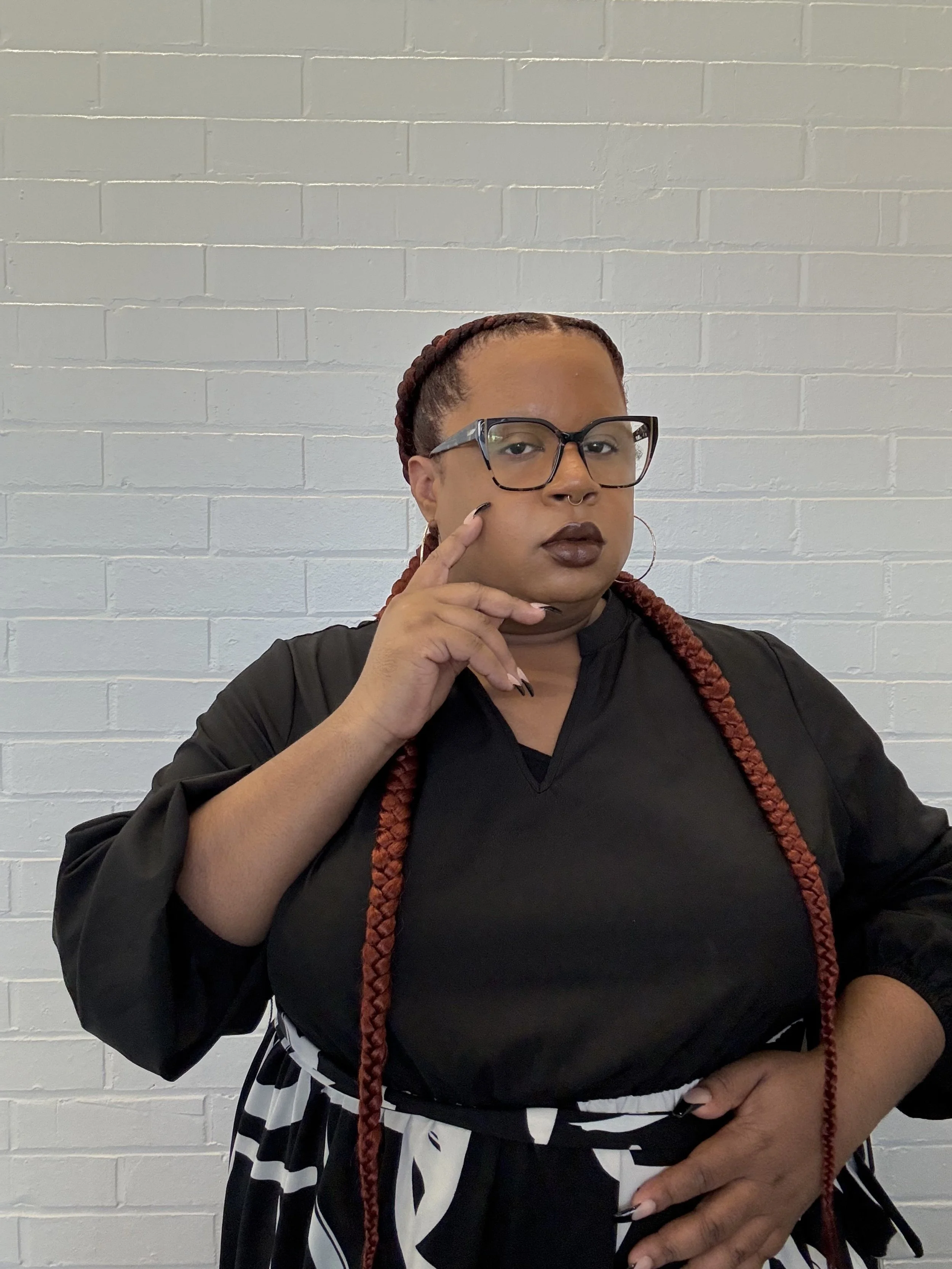 Nalani wearing a black and white dress and glasses