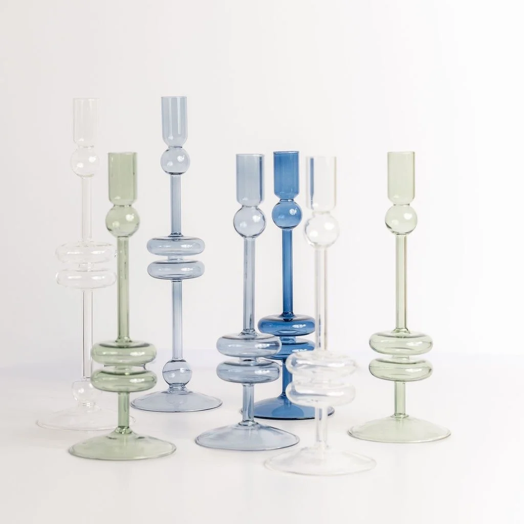 Light dances through soft coastal tones with these elegant glass candlesticks that bring a modern serenity to your home. #coastalliving #minimalisthome #finethings