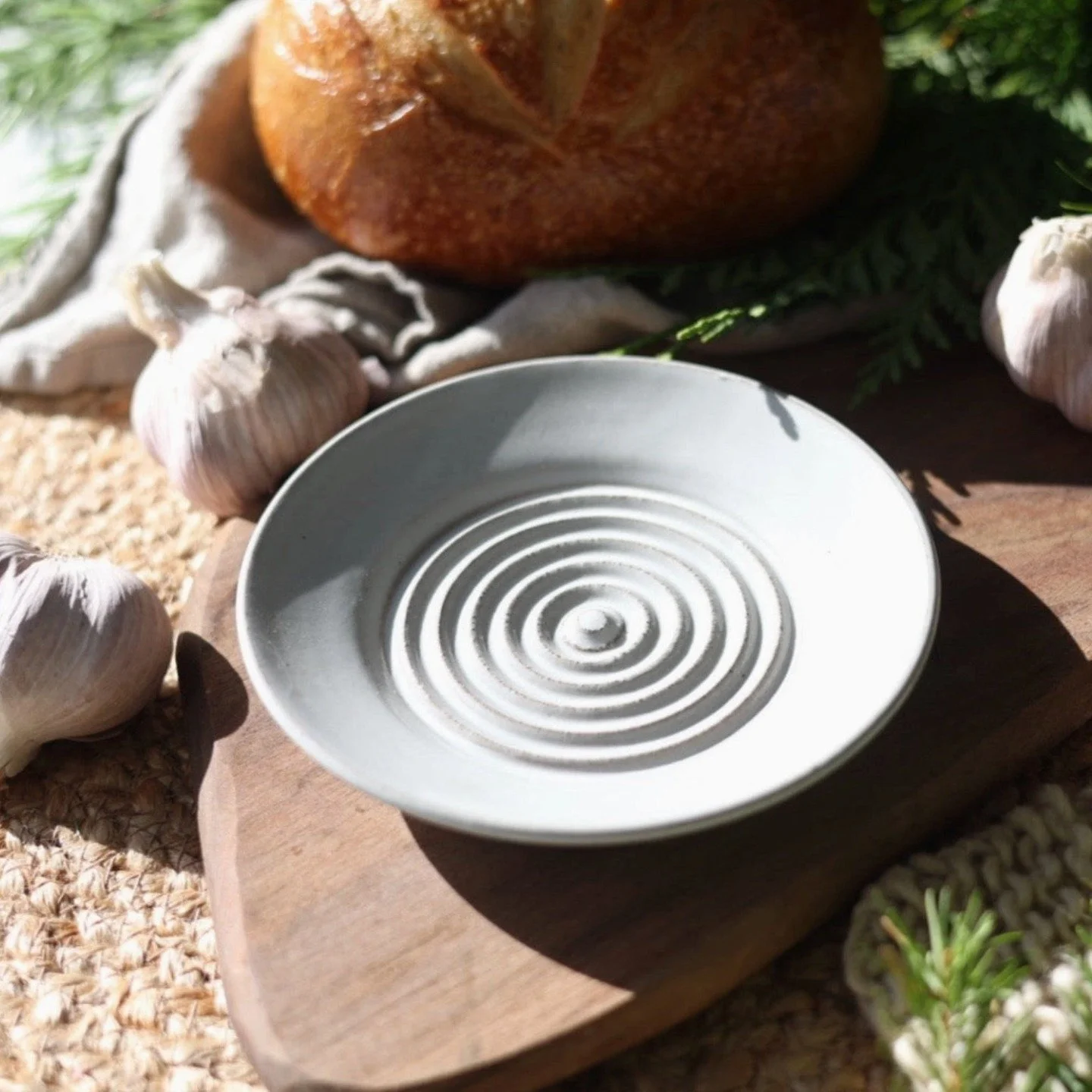 Handcrafted garlic grater plates! The textured surface creates the perfect consistency for oils and dips - just rub a clove across the raised pattern and watch the magic happen. Each plate is wheel-thrown with deep sides to catch every drop of garlic