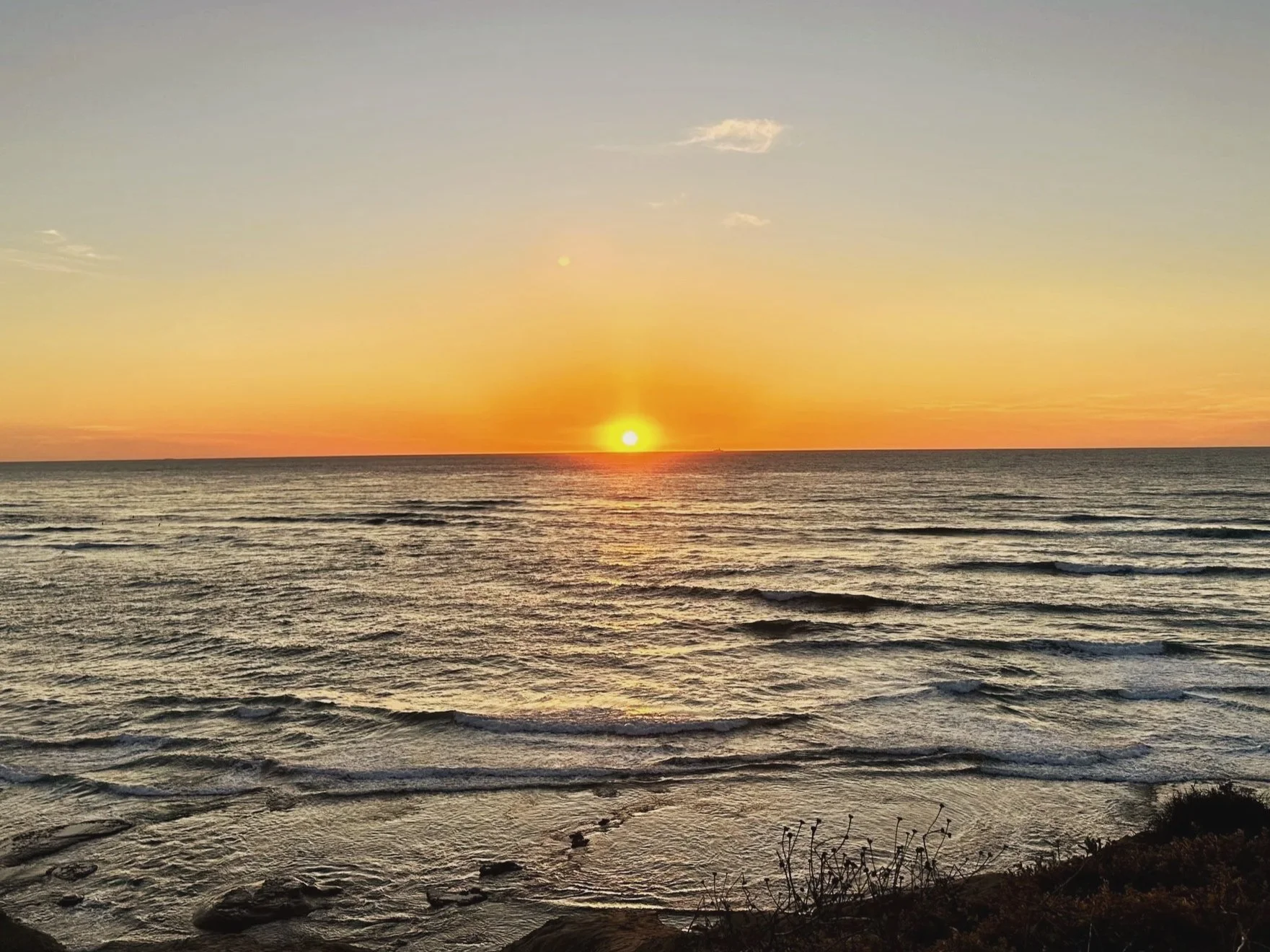 Sun setting low over the ocean horizon, warm light as a visual for gently and sustainably supporting your metabolism