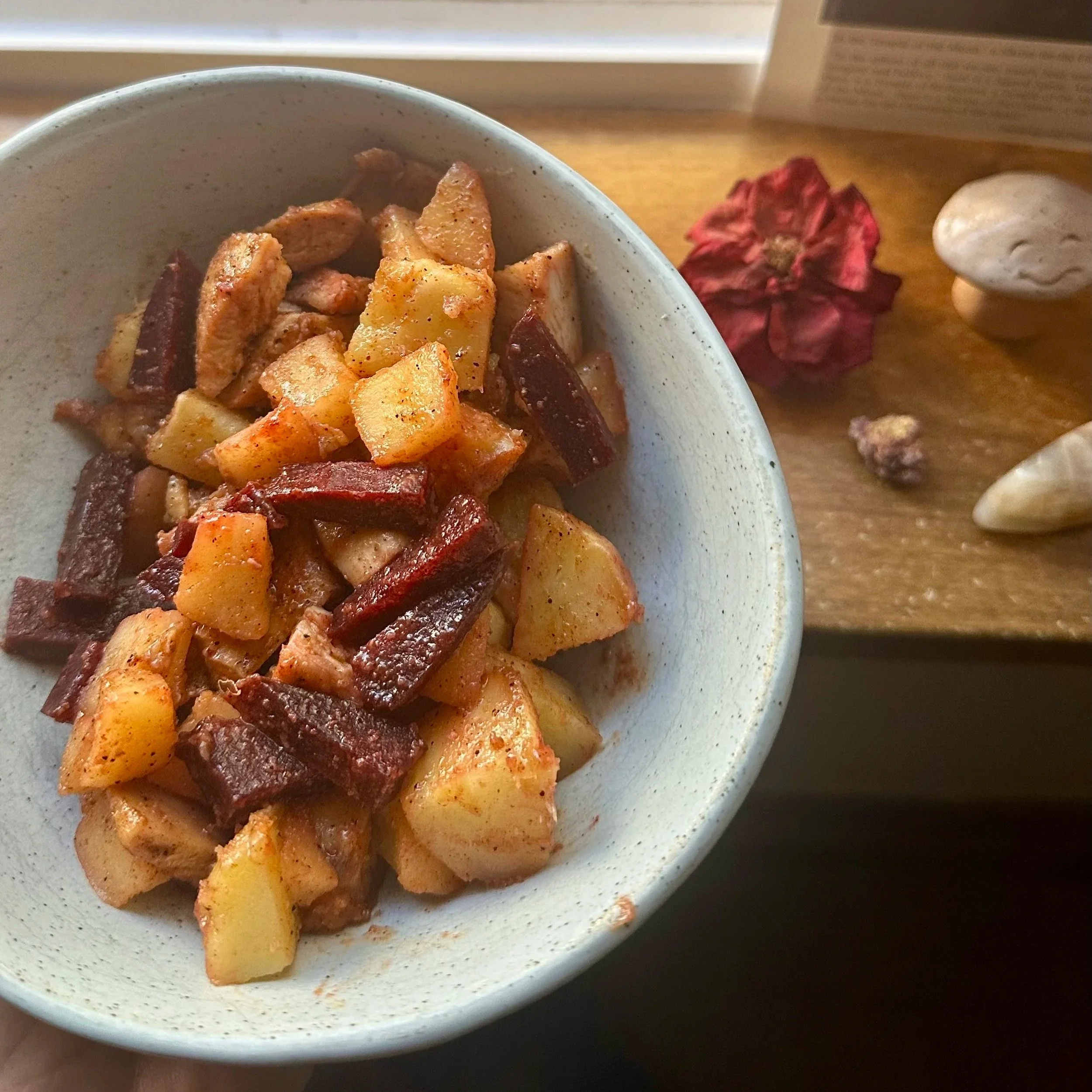 Bowl of nourishing winter foods with stewed apples, beets, potatoes, and carrots, supporting gentle digestion and hormonal balance
