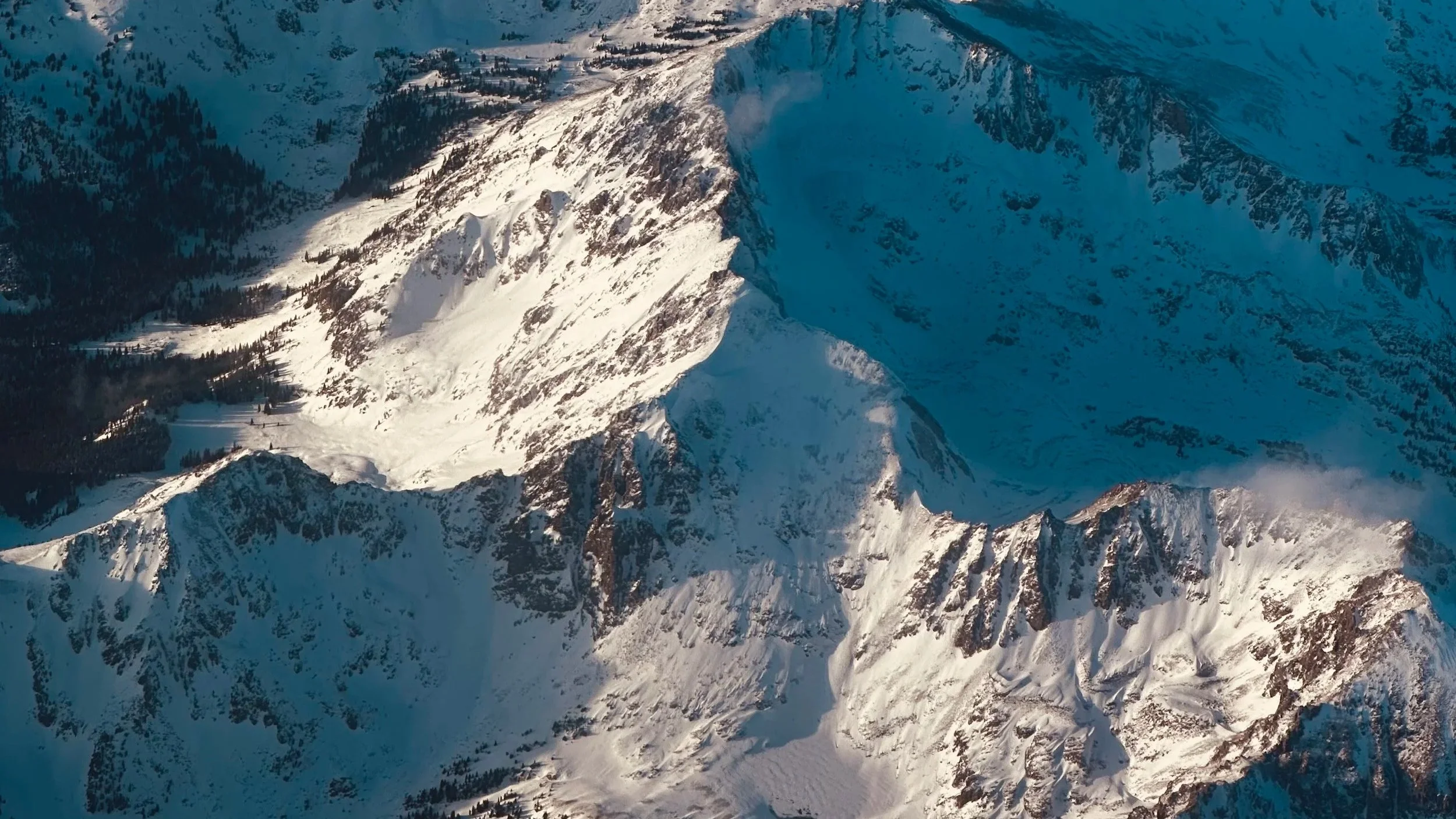 Snow-covered mountain peaks symbolizing winter rest, reflection, and slow, seasonal healing