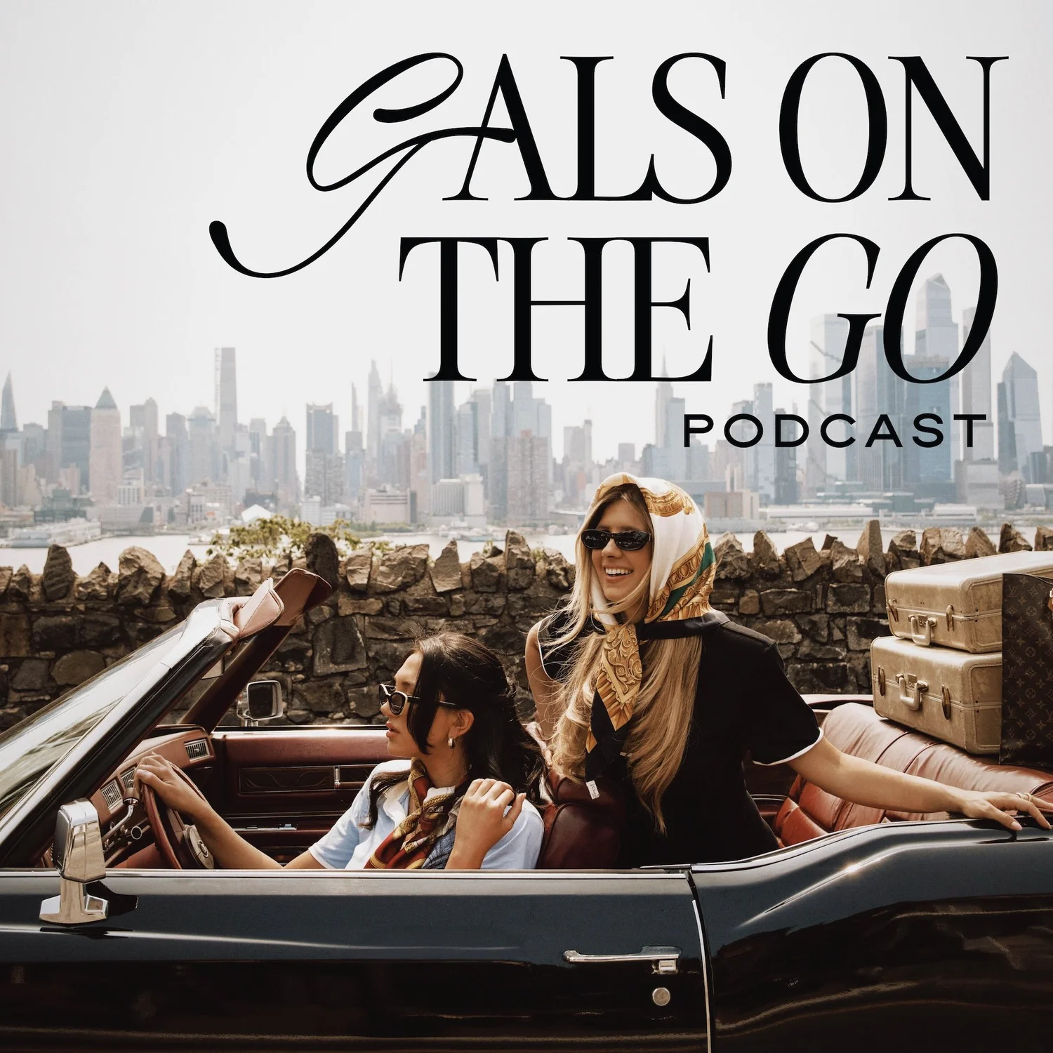 Two women in pink dresses stand in front of a pink background with illustrations including a plane, car, and coffee cup. "Gals on the Go" text is displayed above them. PodcastOne logo is in the bottom corner.