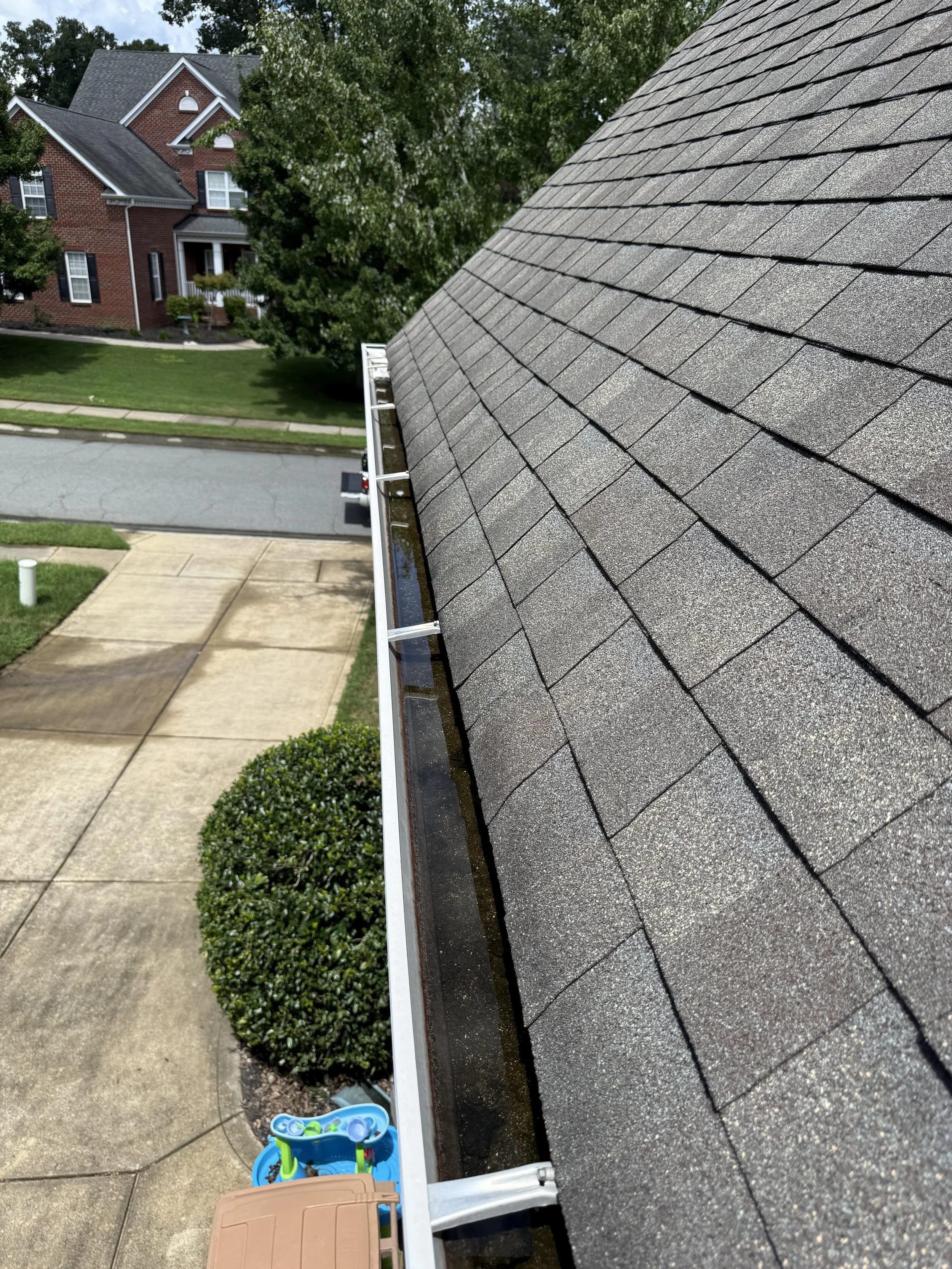Clogged gutters with water pooling unclogged by Stable Roofing in Matthews, NC