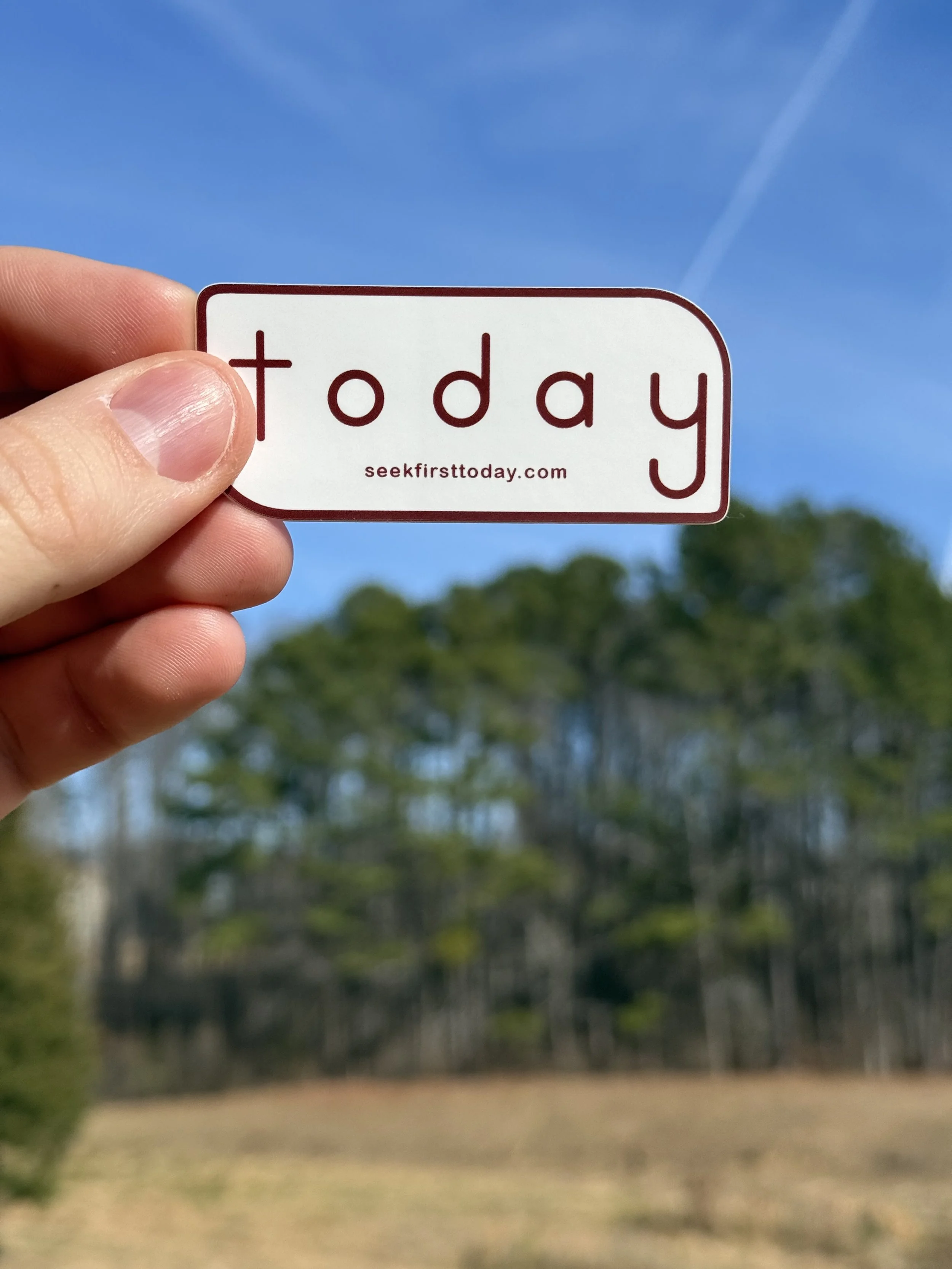 white-and-maroon-seek-first-today-sticker-with-trees-and-blue-sky-in-background