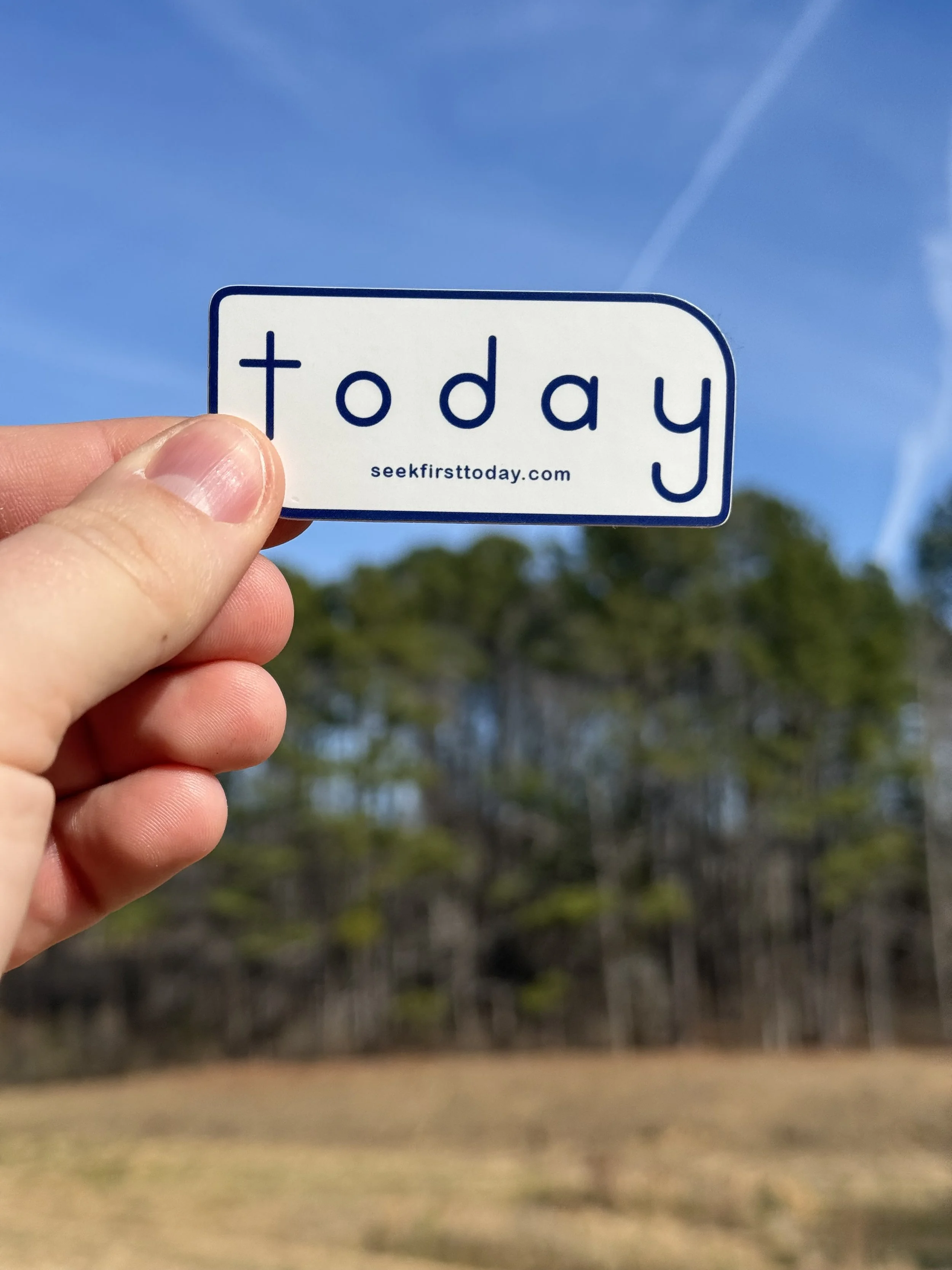white-and-navy-seek-first-today-sticker-with-trees-and-blue-sky-in-background
