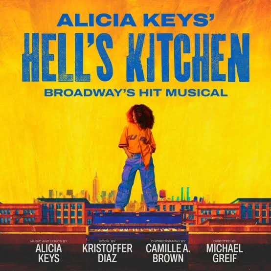 Cover of the musical 'Hell's Kitchen' by Alicia Keys, featuring a person with curly hair in an orange shirt and jeans standing on a cityscape background with a yellow sky.