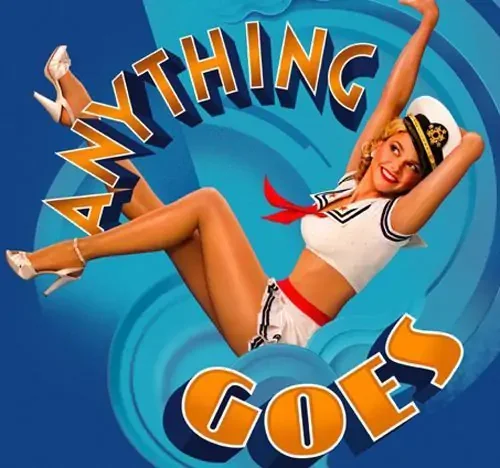 A smiling woman in a retro sailor outfit with a white top, red necktie, and white shorts lying on her back with her legs lifted and arms behind her head, with the text 'ANYTHING GOES' in large colorful letters above her.