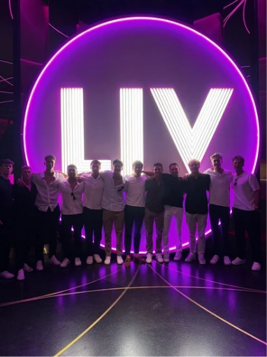 College students on a Las Vegas Fall Break trip standing in front of the LIV nightclub sign during a nighttime group travel experience.