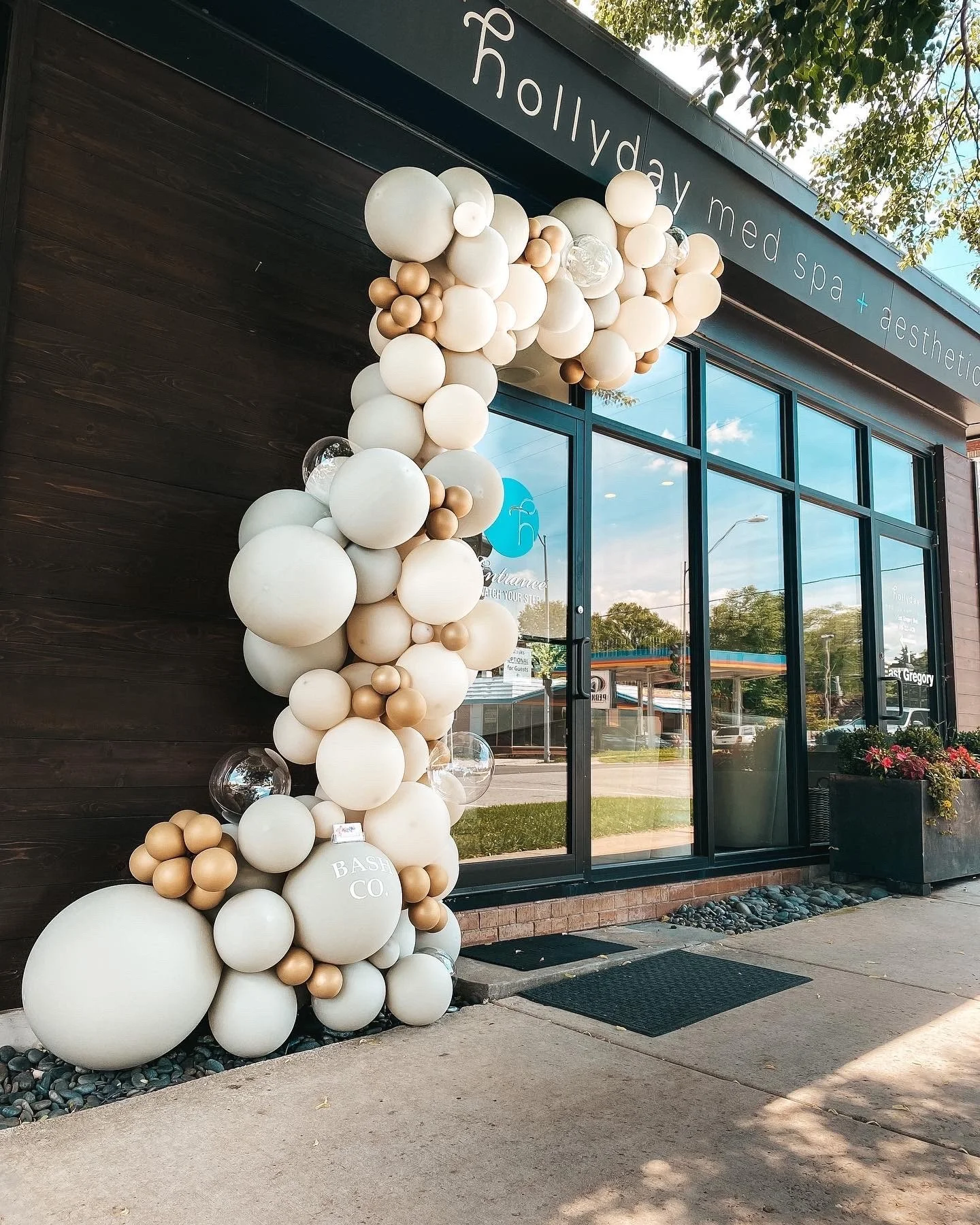 Balloon arch in neutral colors outside a med spa