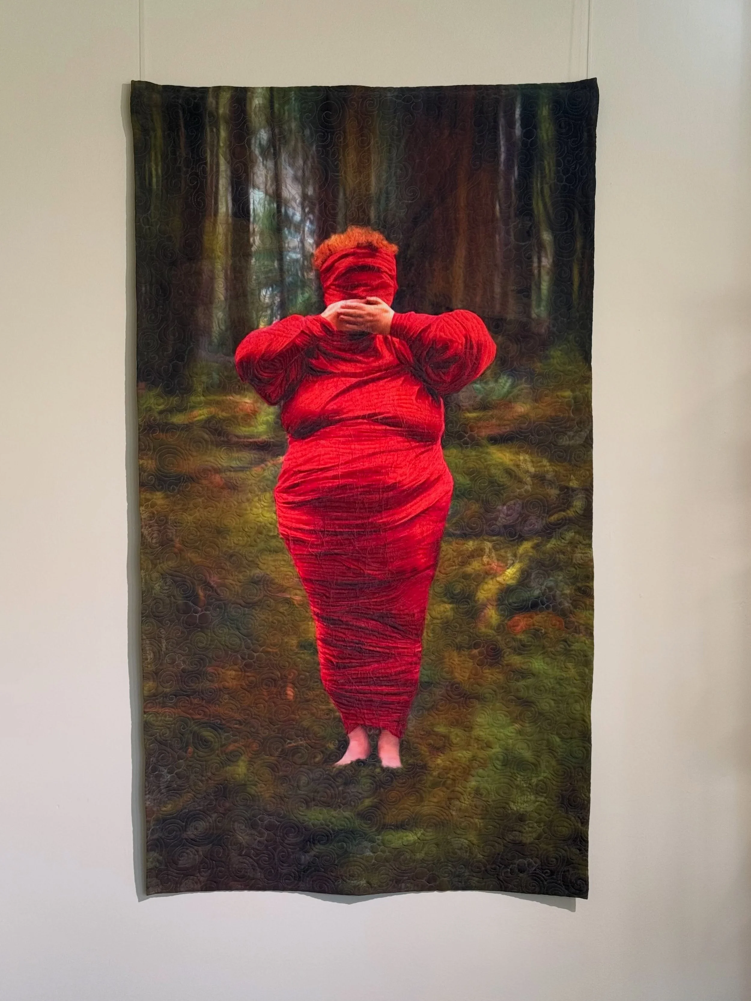 @tashaowenquilting work has an immediate impact from across the room&mdash;the figure, the color, the setting.

But up close, the work begins to shift. Different stitch patterns emerge across the hand and background, fibers build texture through the 