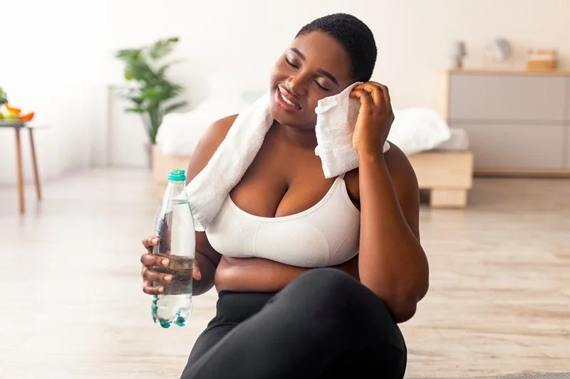 plus size african american lady taking break from workout