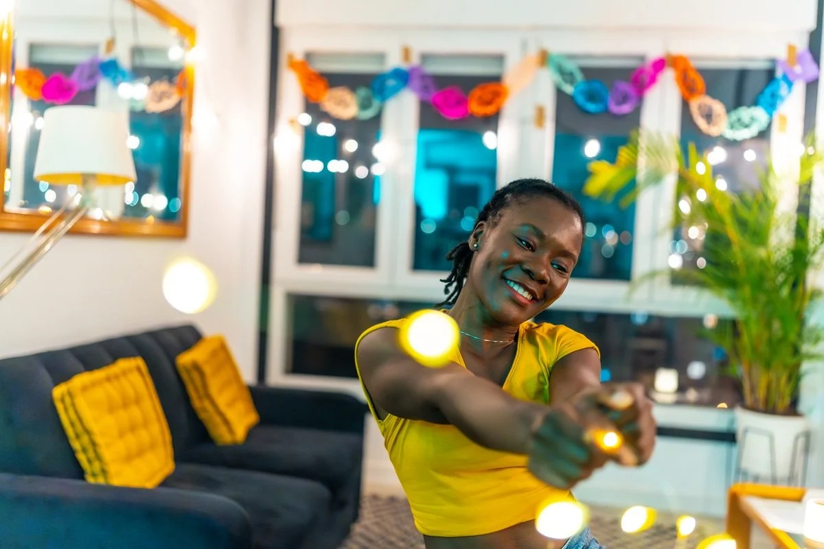 smiling woman dancing in decorated home