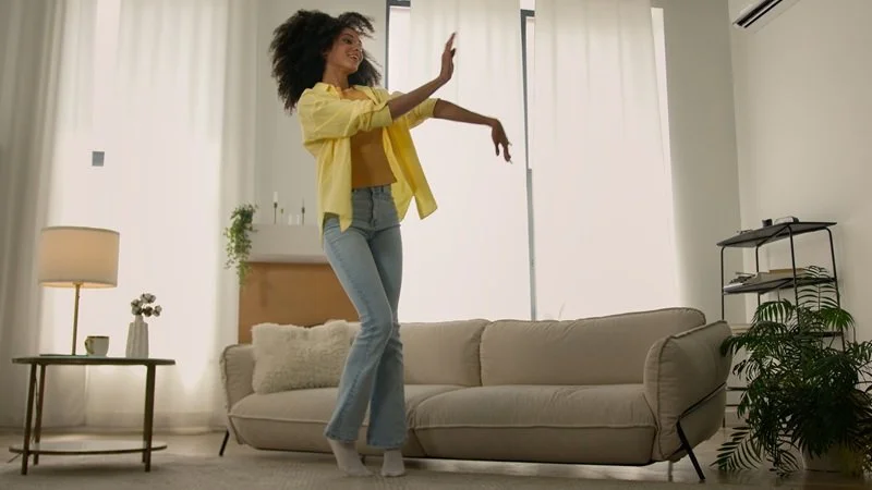 a woman smiling slightly while moving, clearly comfortable and at ease in her body.