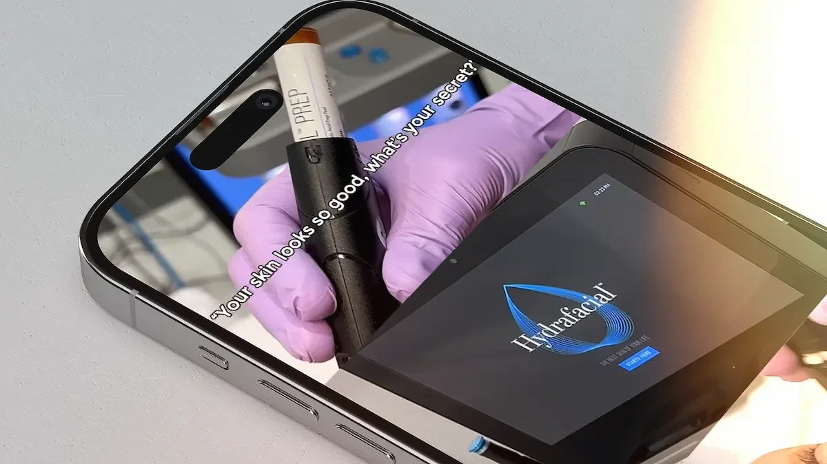 Smartphone displaying a digital marketing skincare advertisement for a Hydrafacial at a medical spa. The form of advertisement is an Instagram reel.