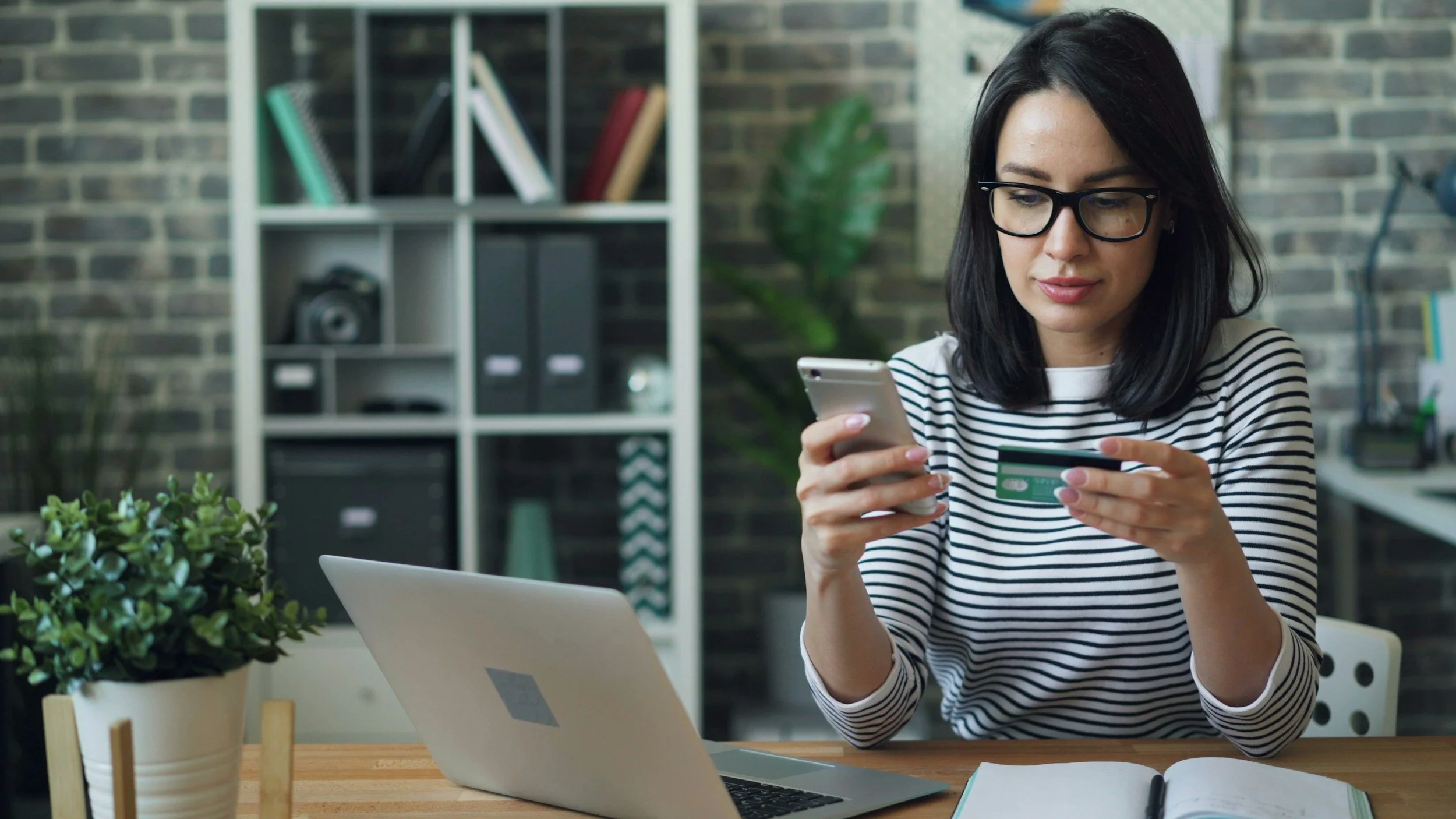 Woman making a payment on her cell phone.