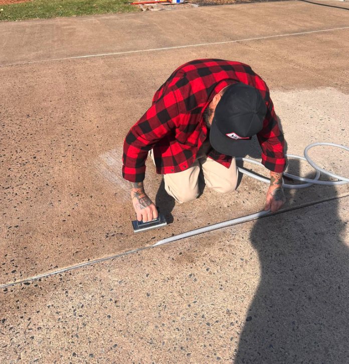 An Action Construction Employee Prepping a Driveway